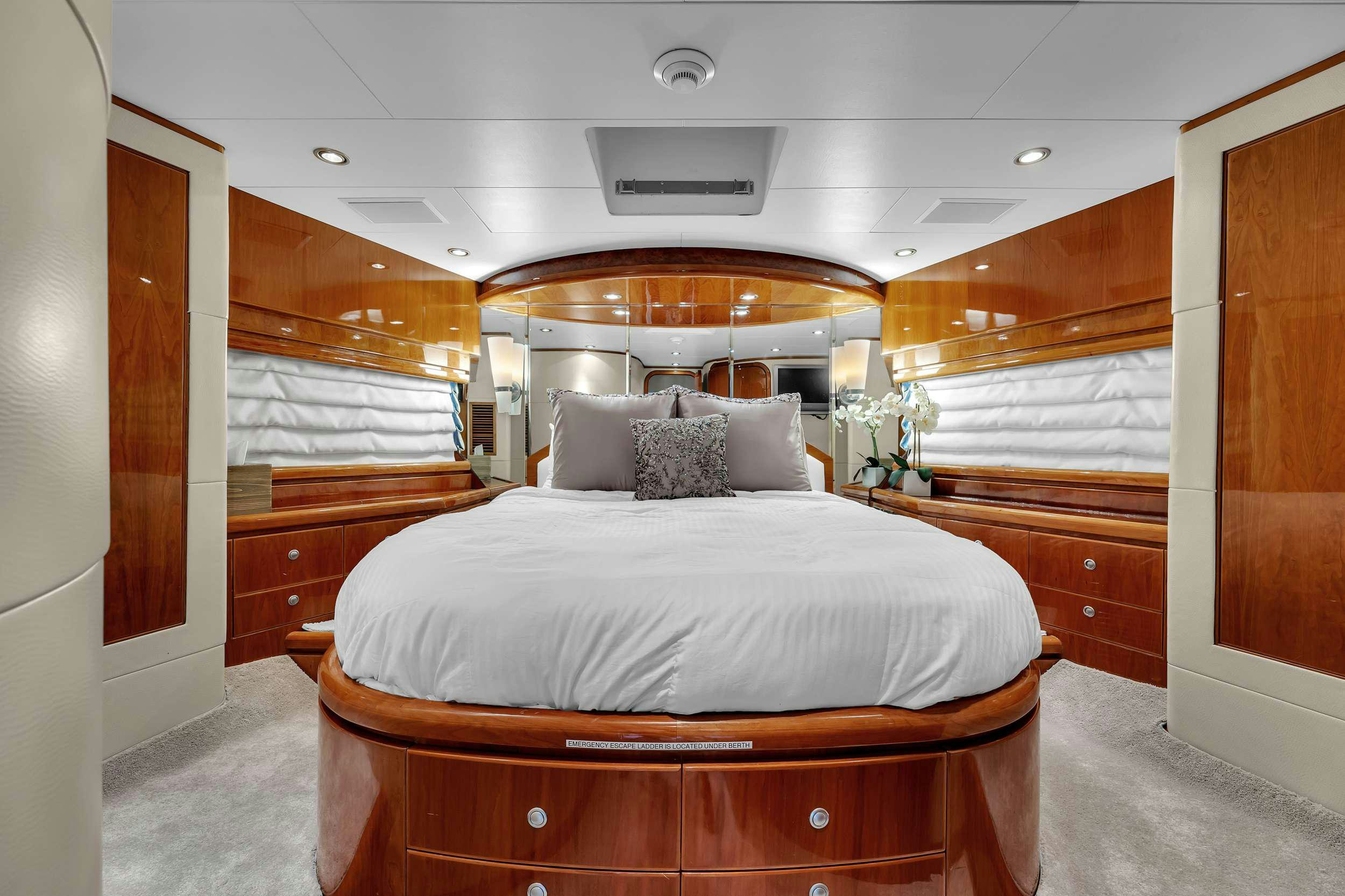 a room with a bed and a dresser aboard DREAM ON Yacht for Charter