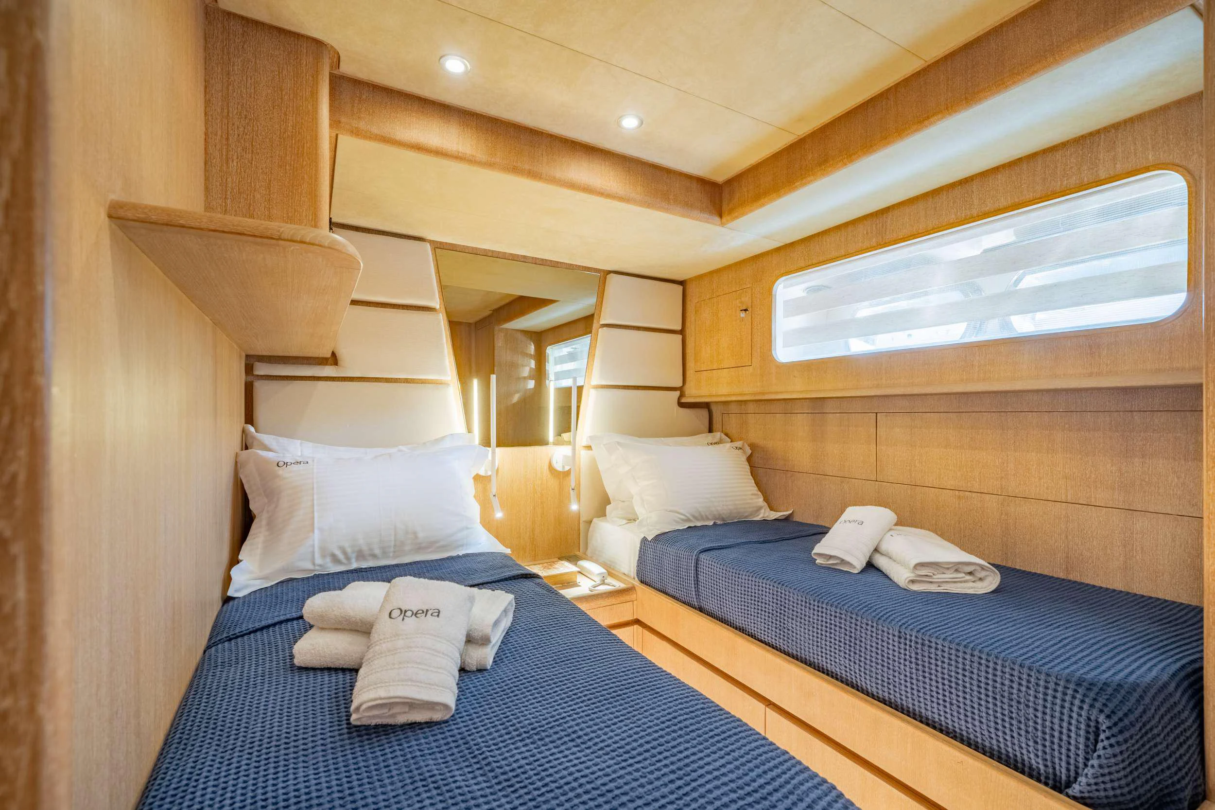 a room with a bed and a window aboard OPERA Yacht for Charter
