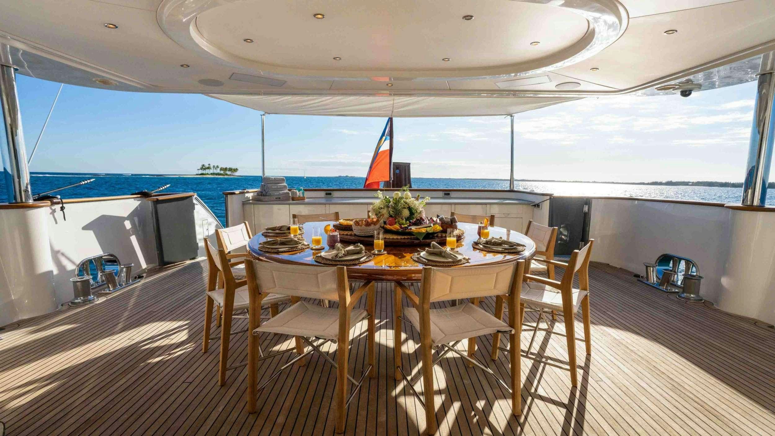 a dining table on a deck aboard STAY SALTY Yacht for Charter