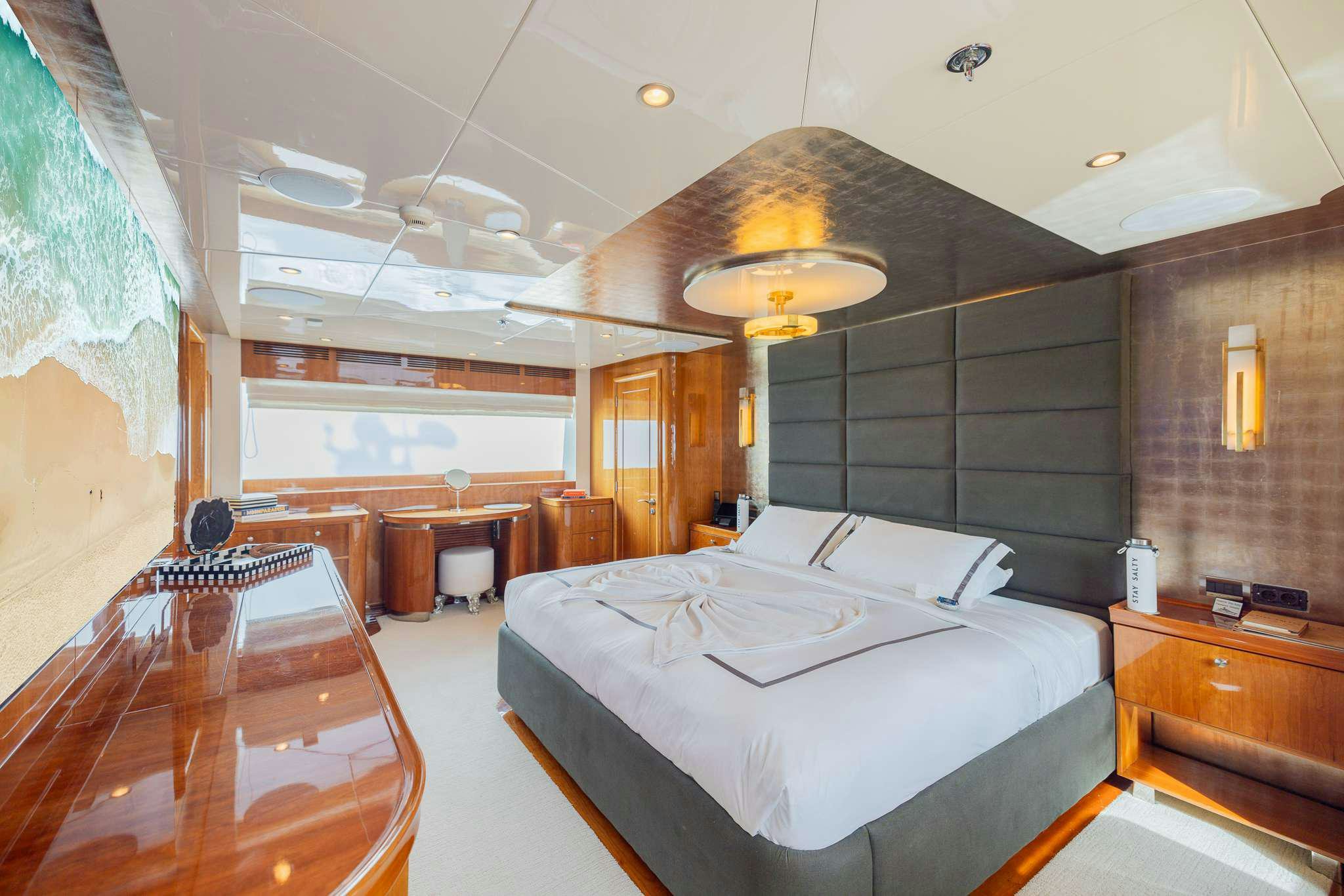 a room with a bed and a table aboard STAY SALTY Yacht for Charter