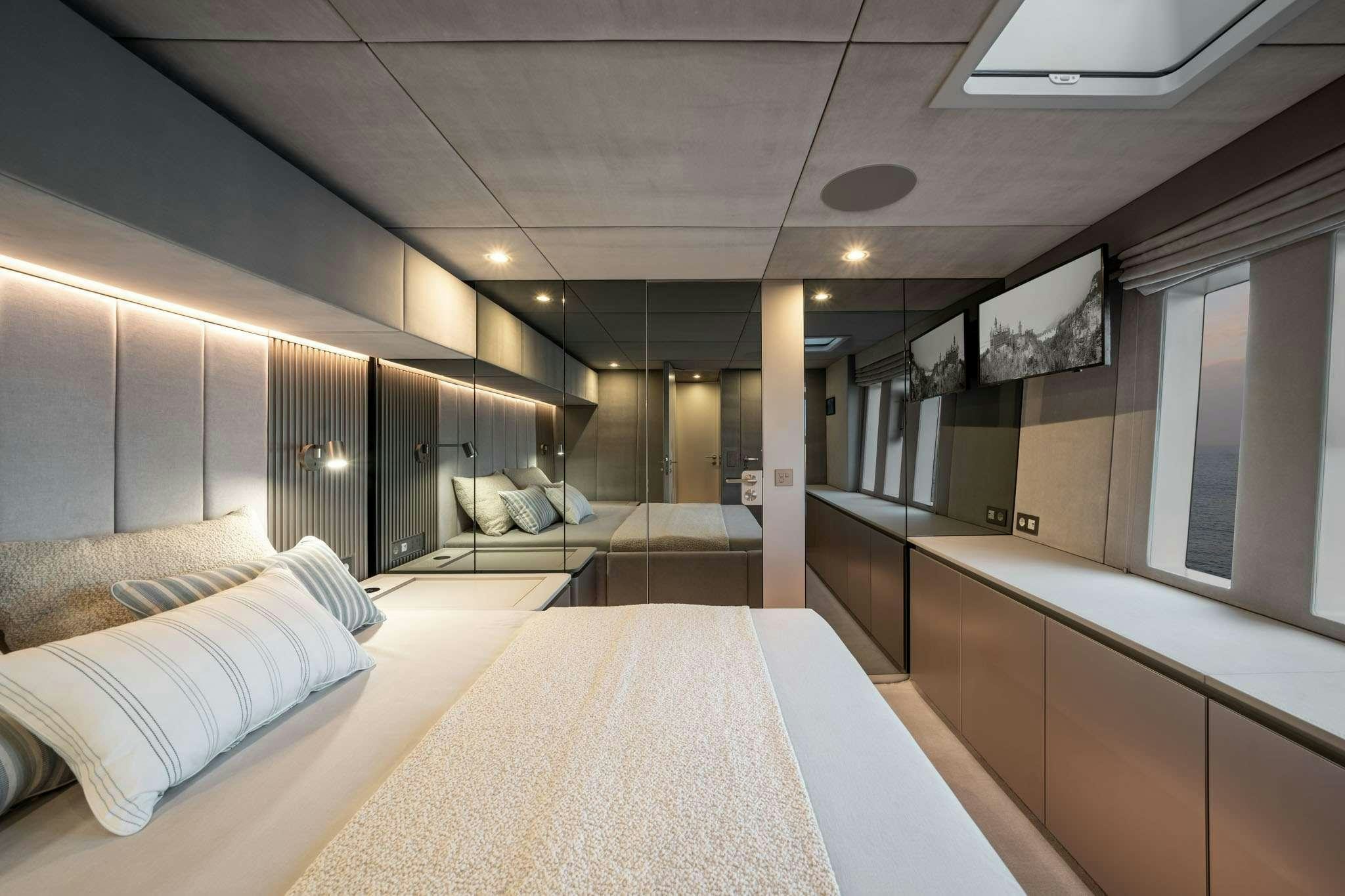a large room with a bed and a large window aboard HALCYON Yacht for Charter