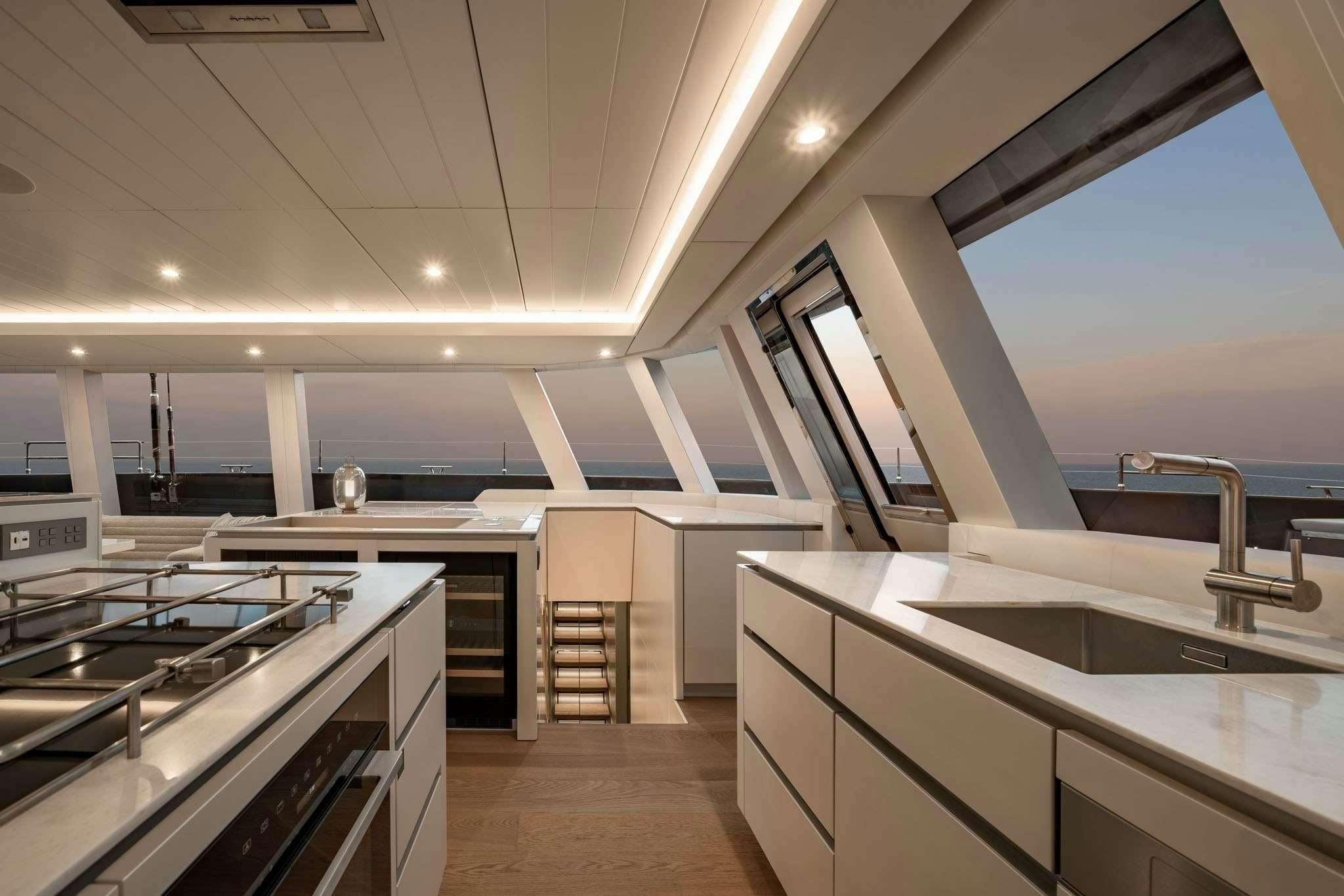 a kitchen with white cabinets aboard HALCYON Yacht for Charter