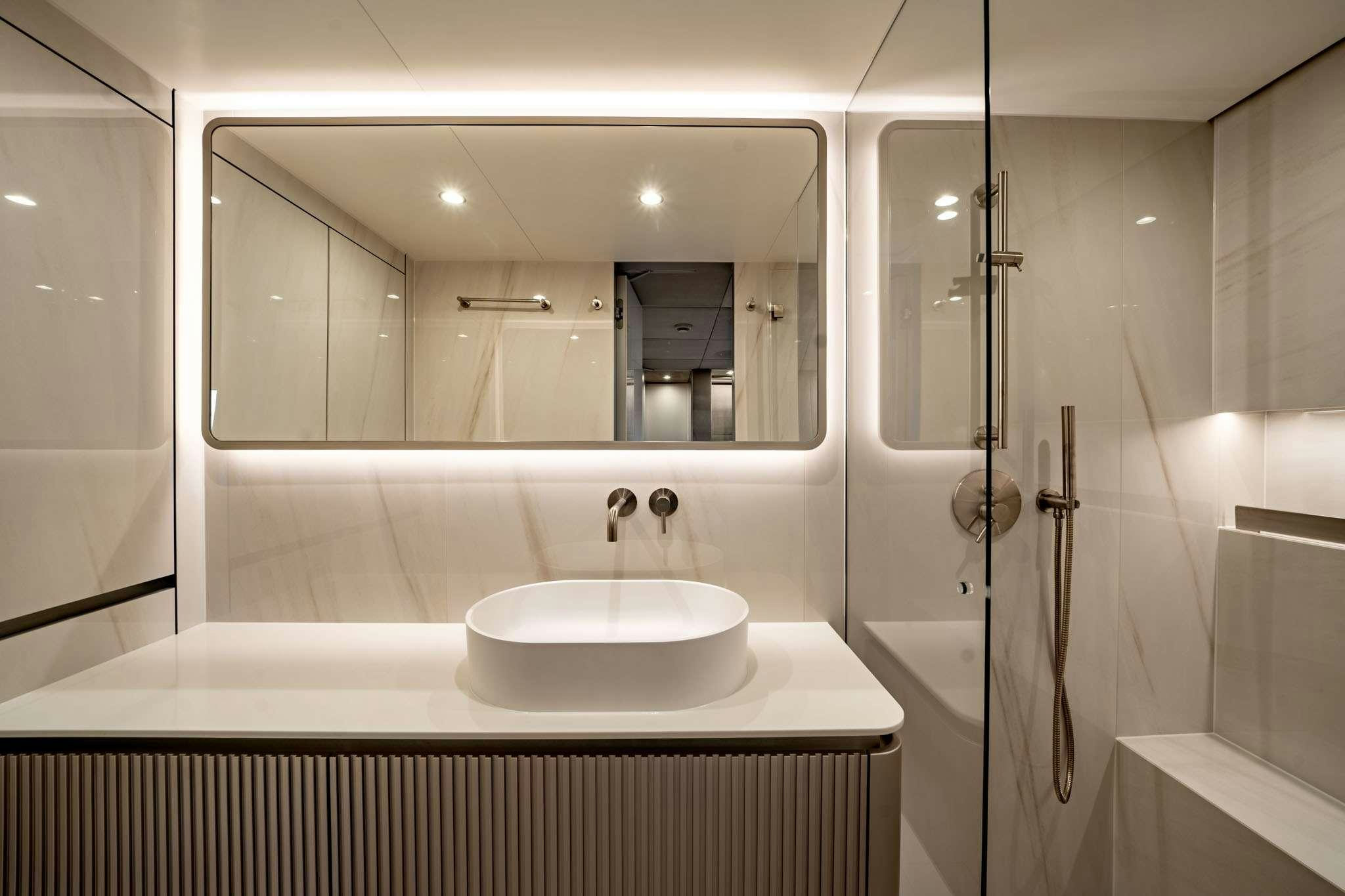 a bathroom with a large mirror aboard HALCYON Yacht for Charter