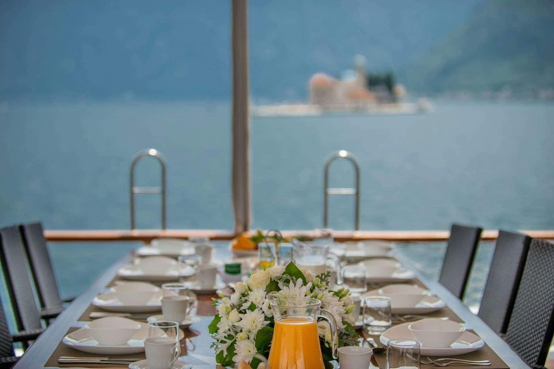 a table set for a dinner aboard SADRI USTA Yacht for Charter