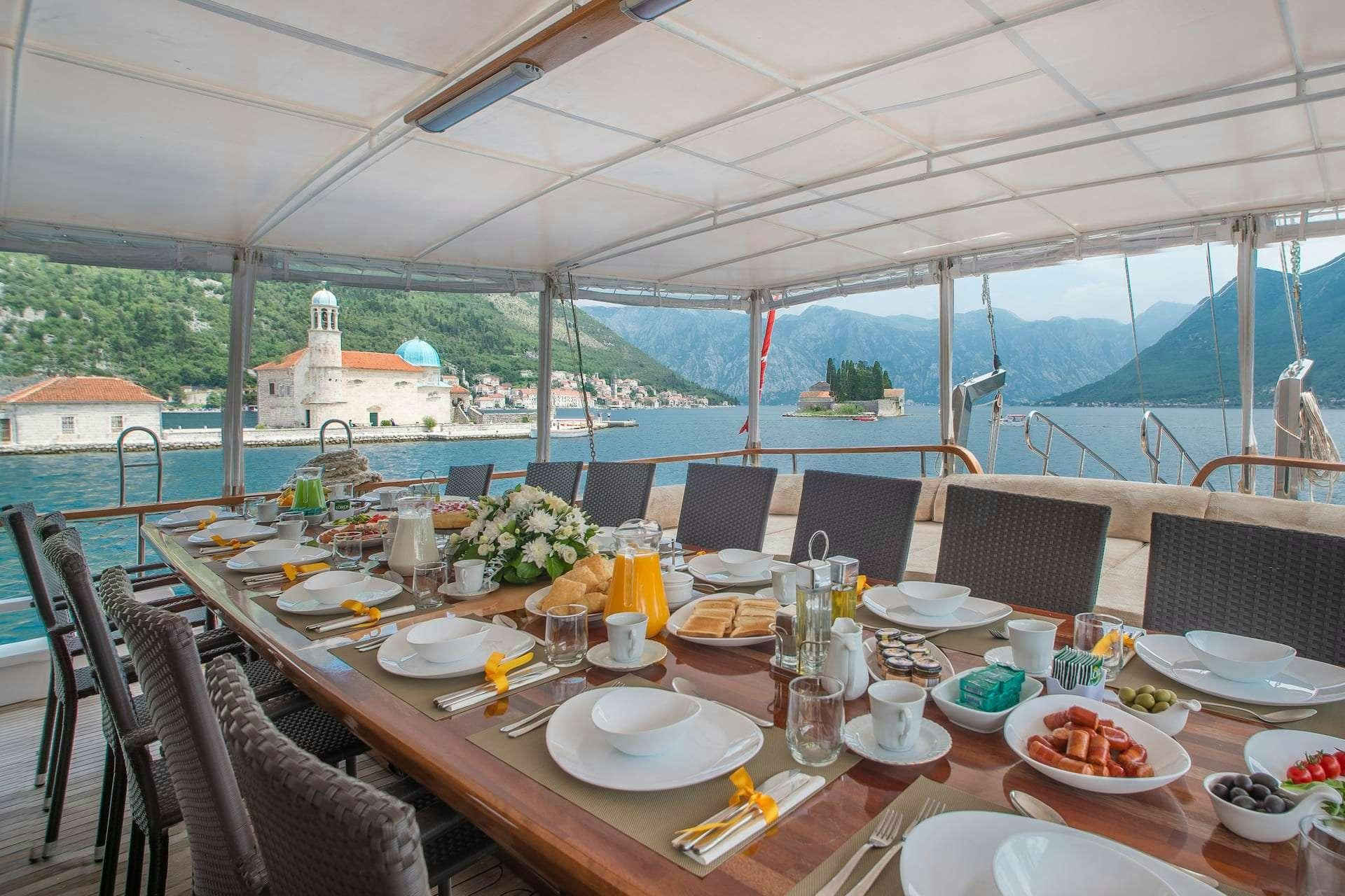 a table set for a meal aboard SADRI USTA Yacht for Charter
