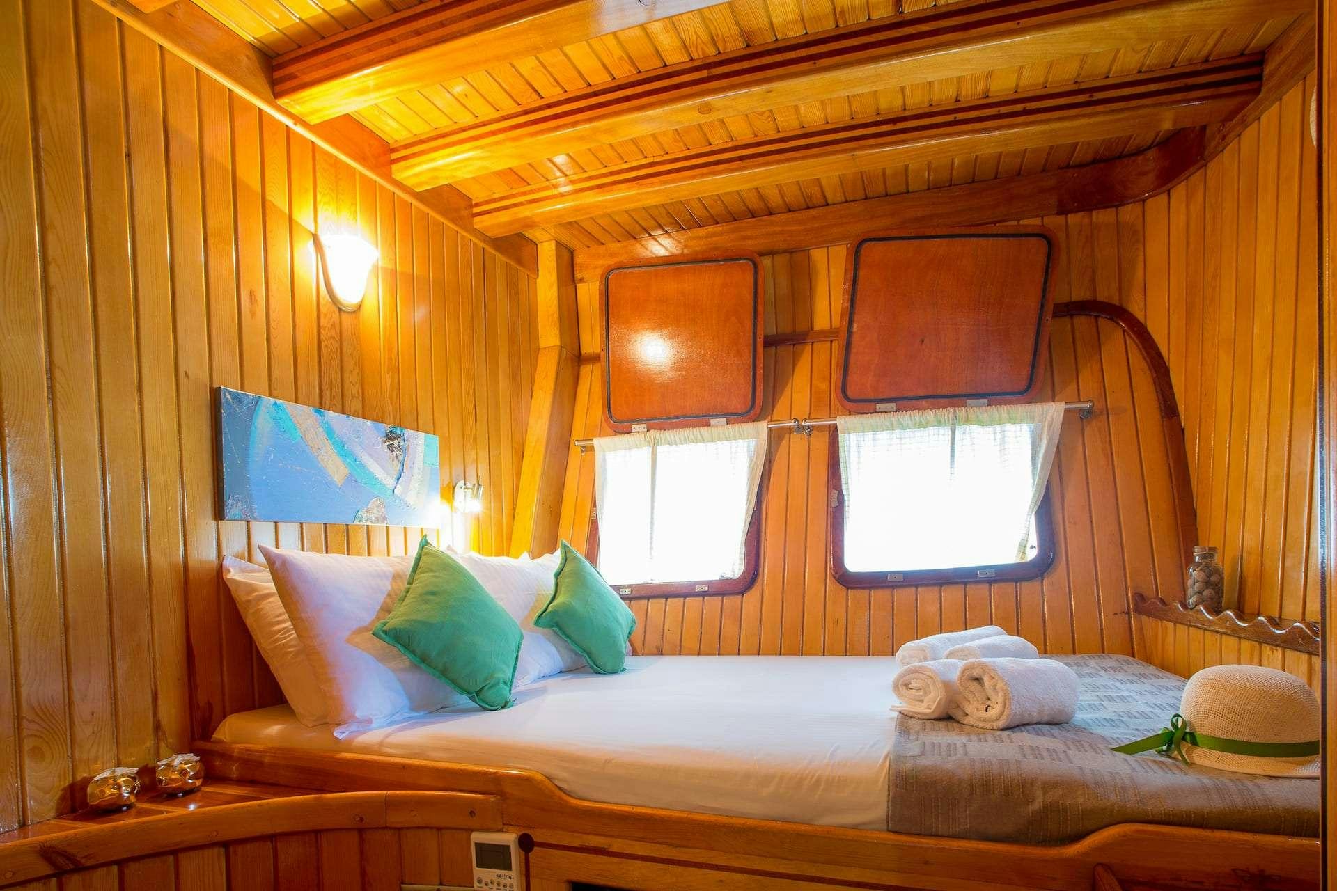 a bed with a wood canopy aboard SADRI USTA Yacht for Charter