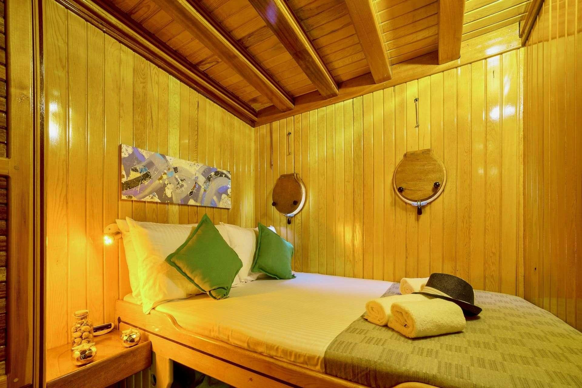 a room with a bed and a lamp aboard SADRI USTA Yacht for Charter