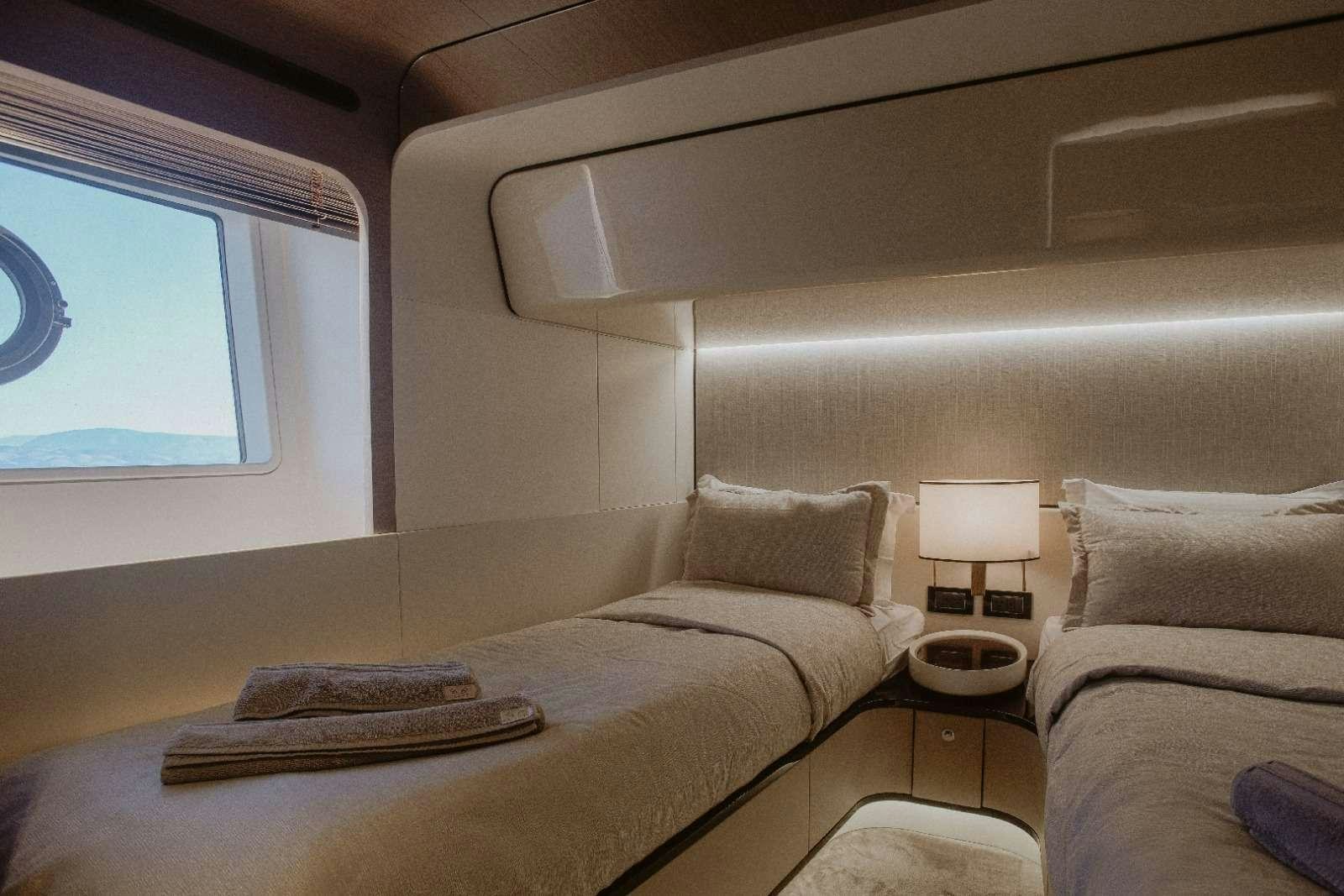 a room with a bed and a lamp aboard AGIO Yacht for Charter