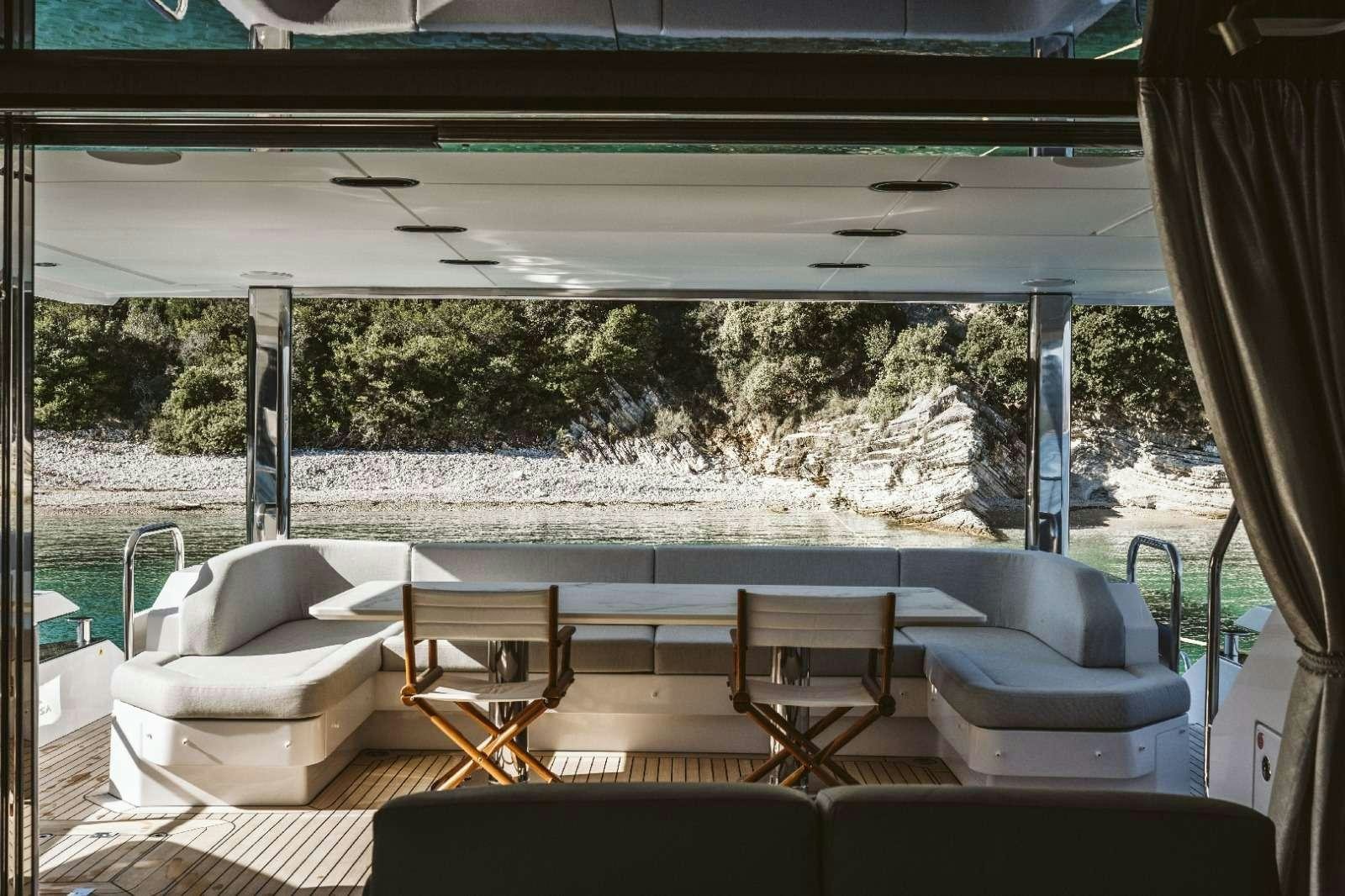 a room with a couch and a table and chairs aboard AGIO Yacht for Charter