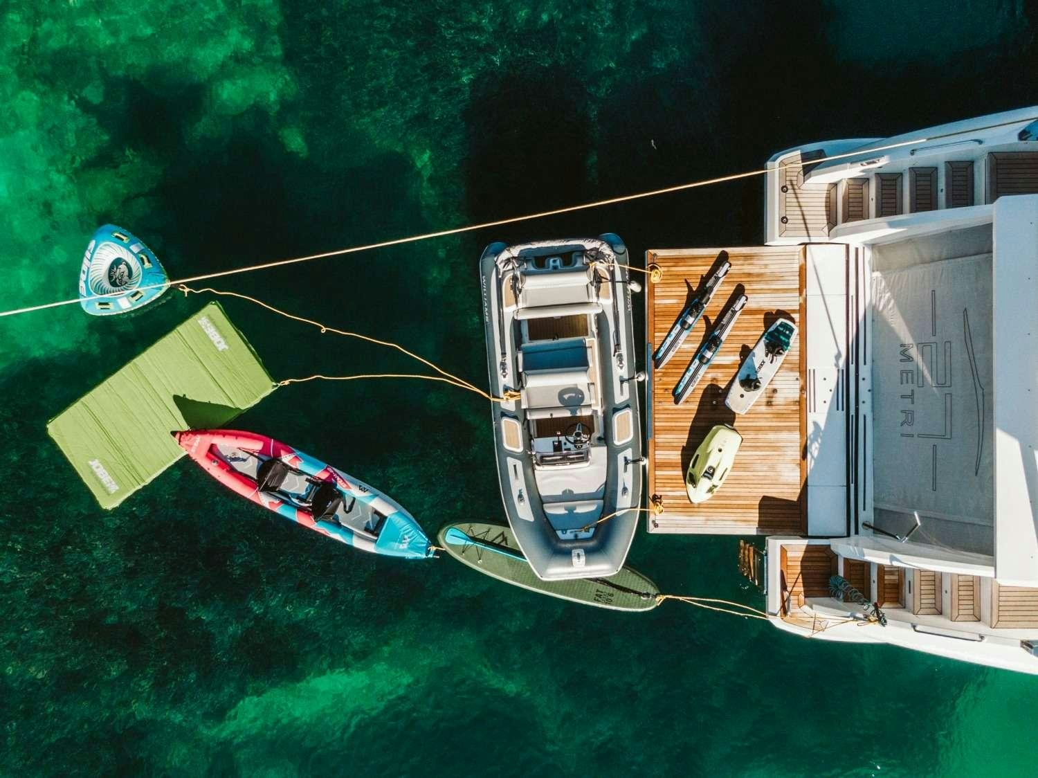 a helicopter flying over a field aboard AGIO Yacht for Charter