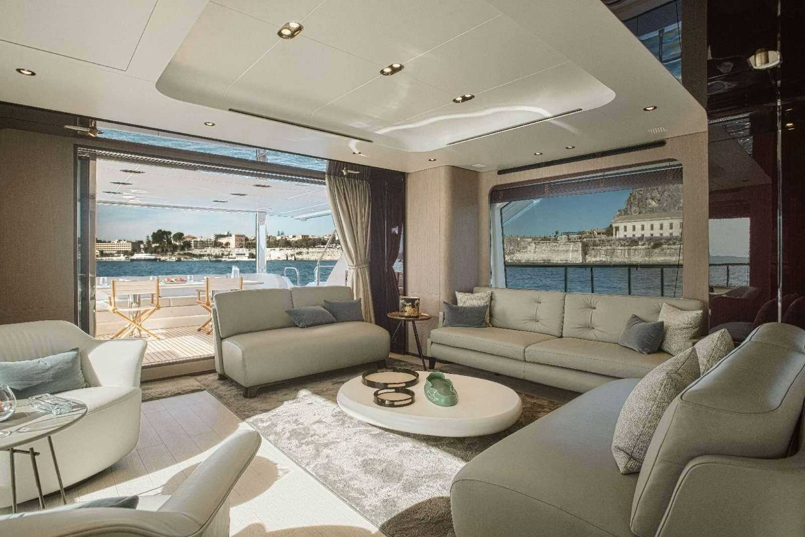 a living room with a large window aboard AGIO Yacht for Charter
