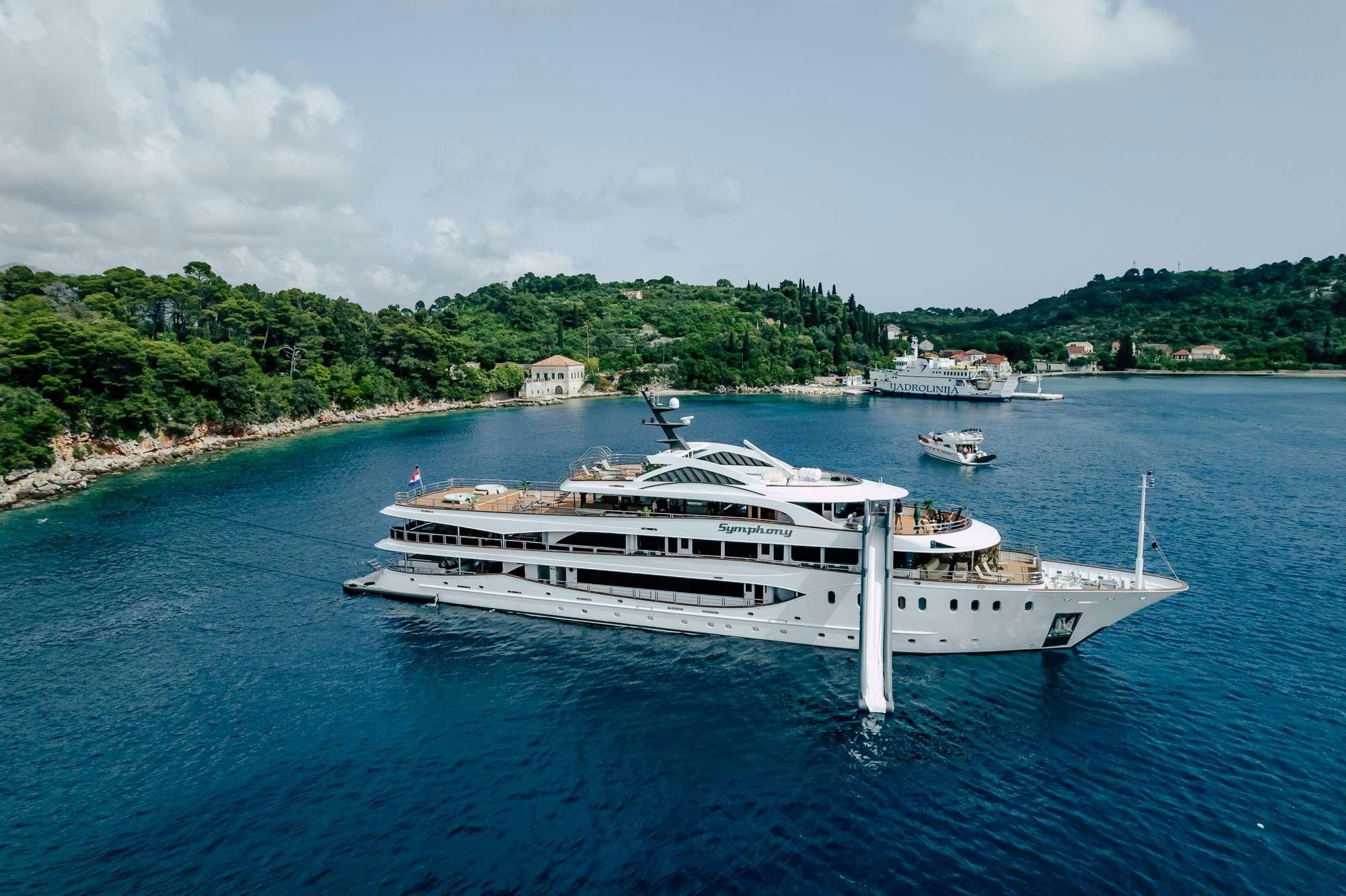 a large white boat in the water aboard SYMPHONY Yacht for Charter