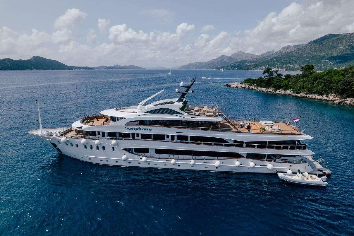 a large cruise ship in the water aboard SYMPHONY Yacht for Charter