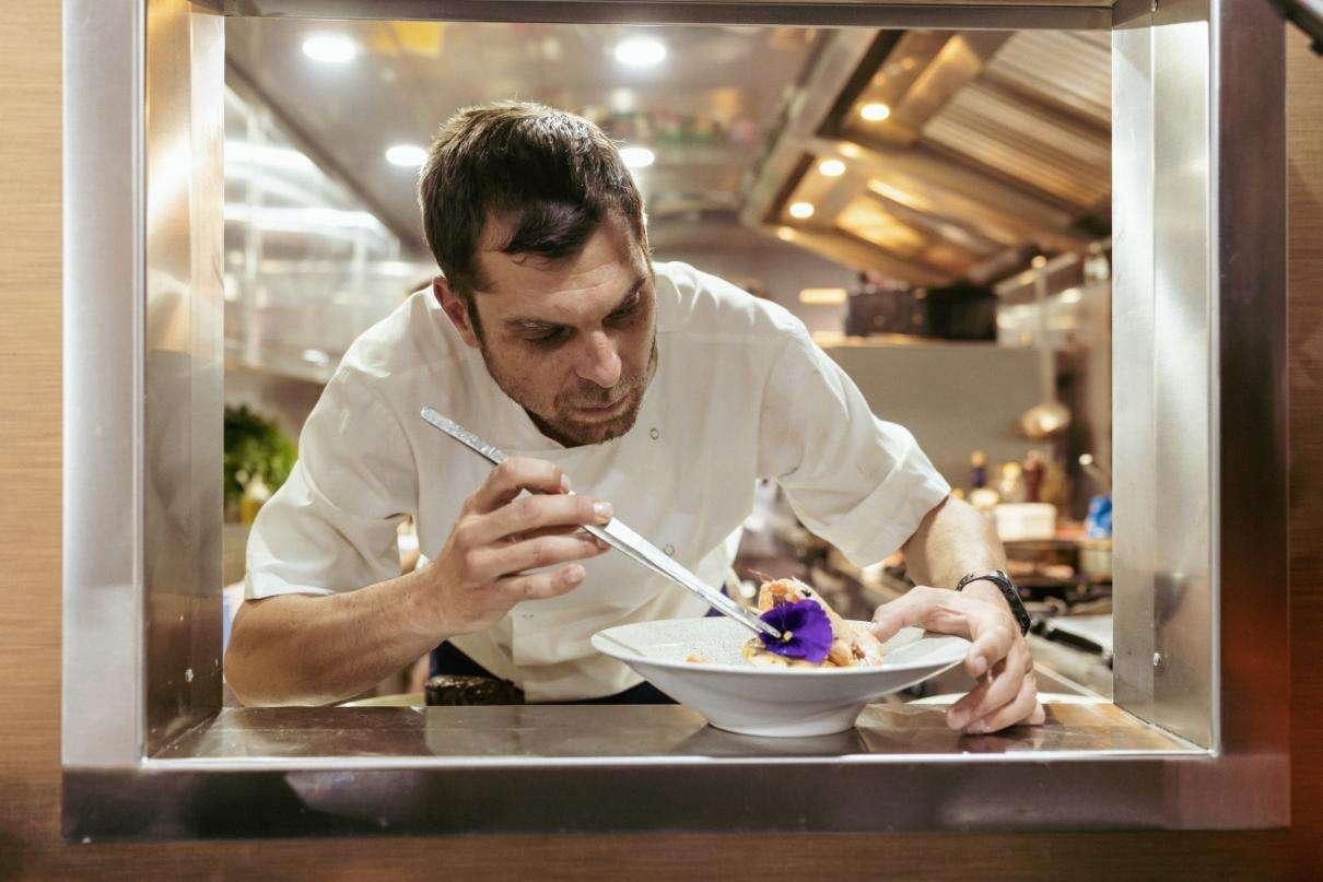 a man eating food aboard SYMPHONY Yacht for Charter