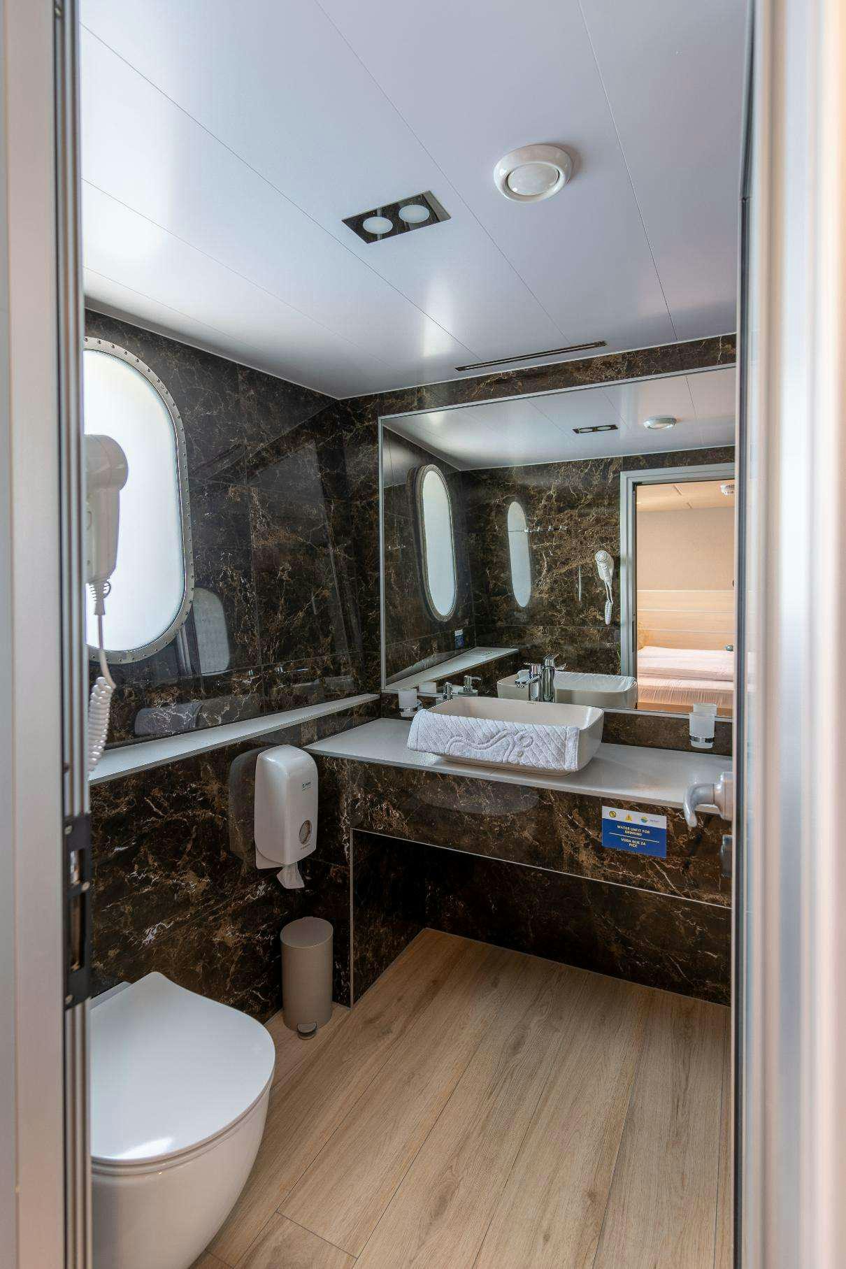 a bathroom with a large mirror aboard SYMPHONY Yacht for Charter
