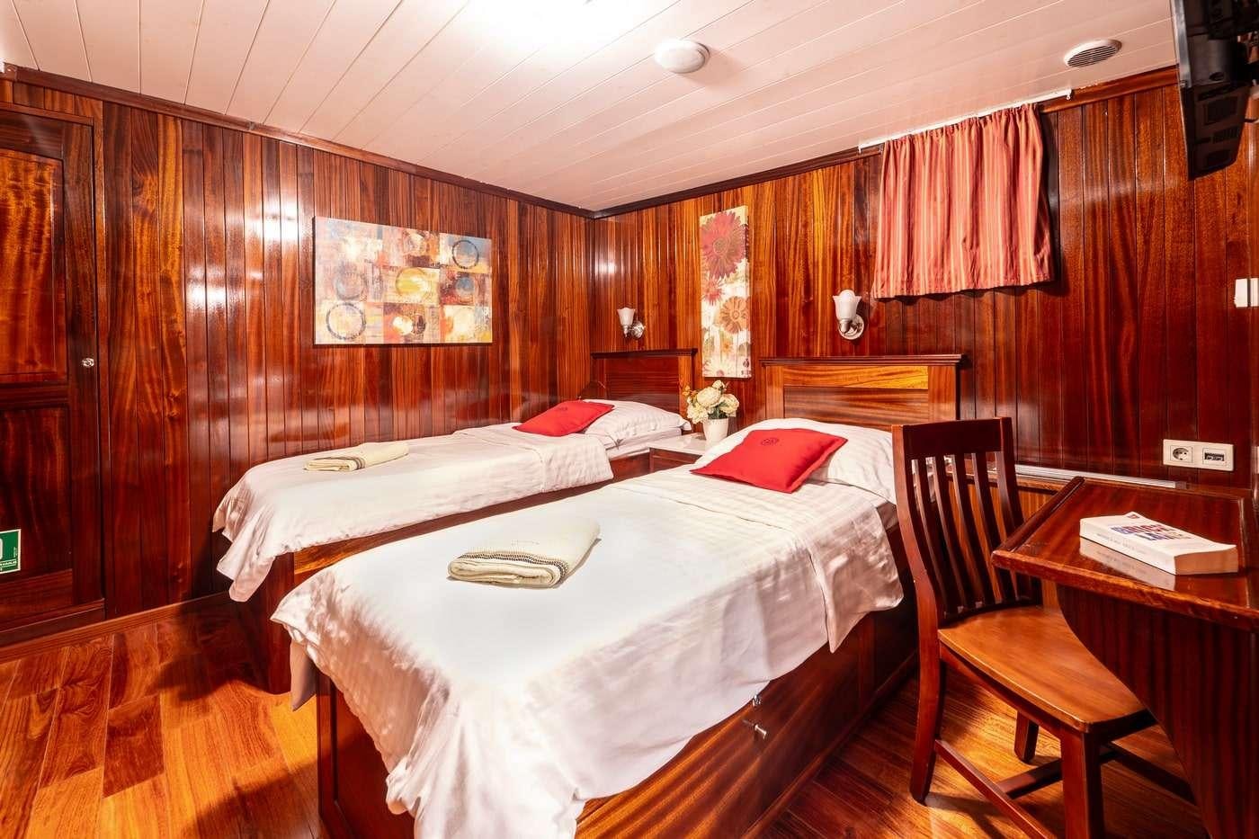 a room with a couple of beds aboard CESARICA Yacht for Charter