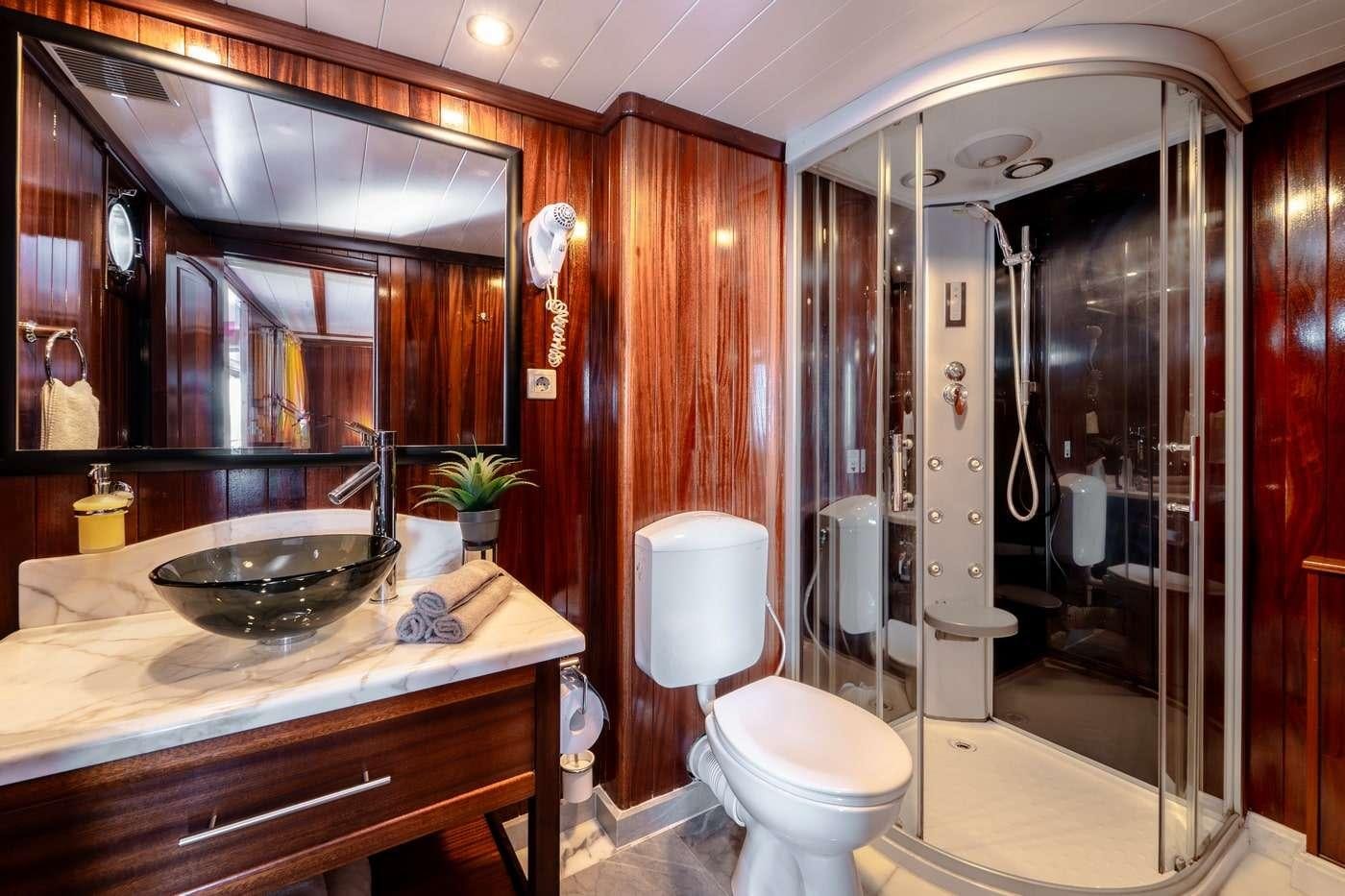 a bathroom with a sink toilet and a bathtub aboard CESARICA Yacht for Charter
