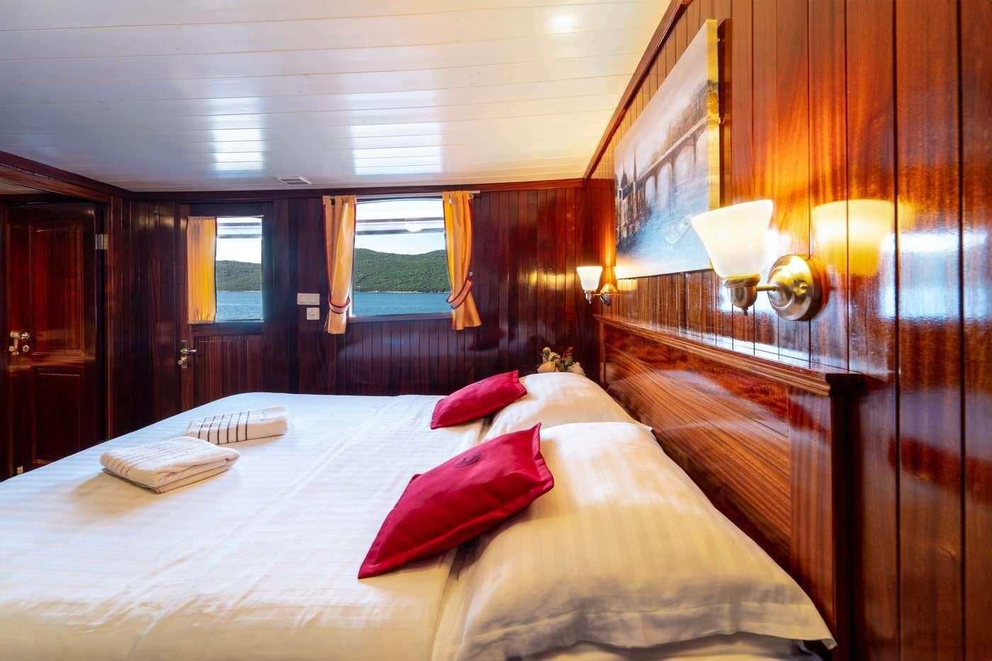 a hotel room with a bed aboard CESARICA Yacht for Charter