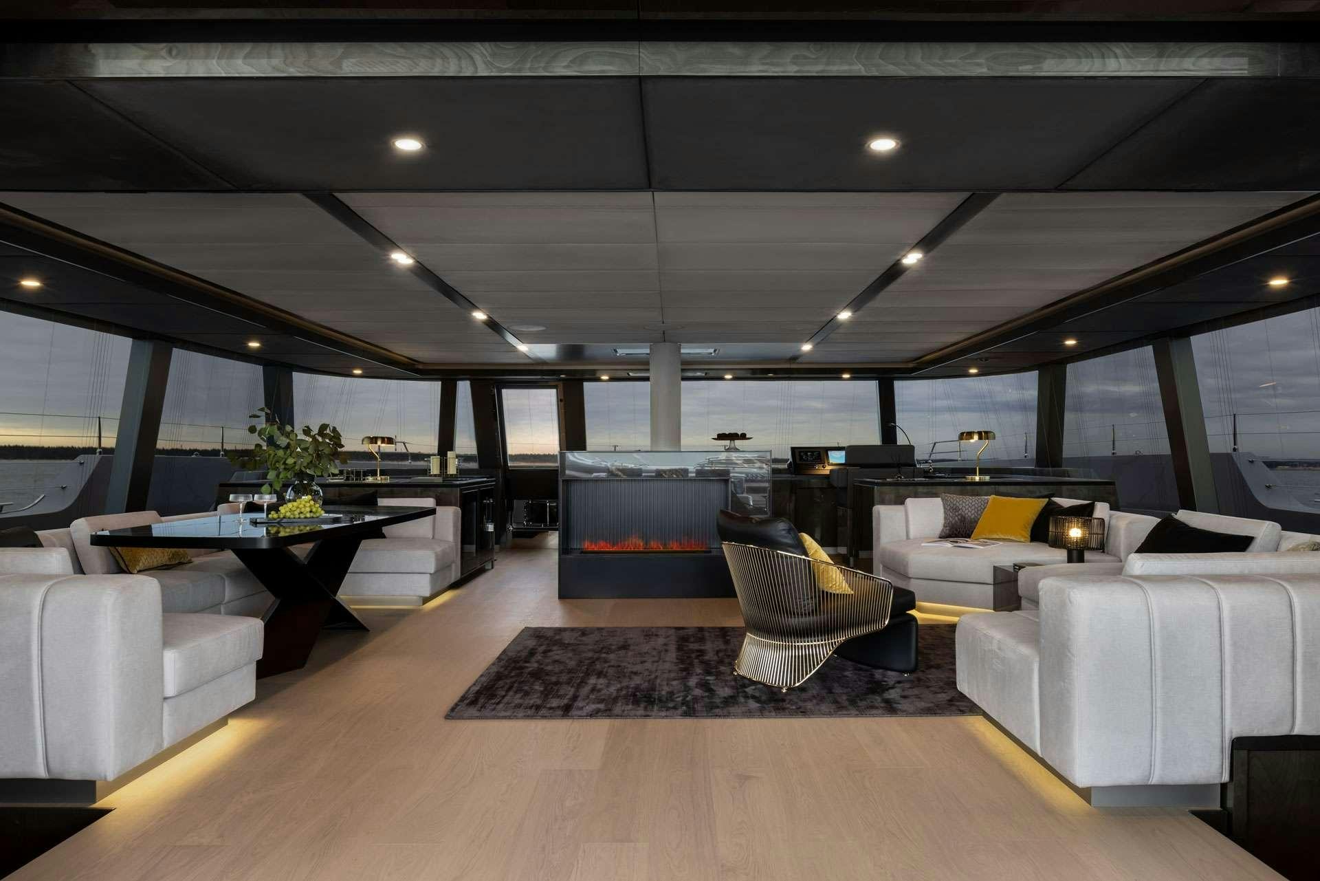 a room with a table and chairs aboard XMOTION Yacht for Charter