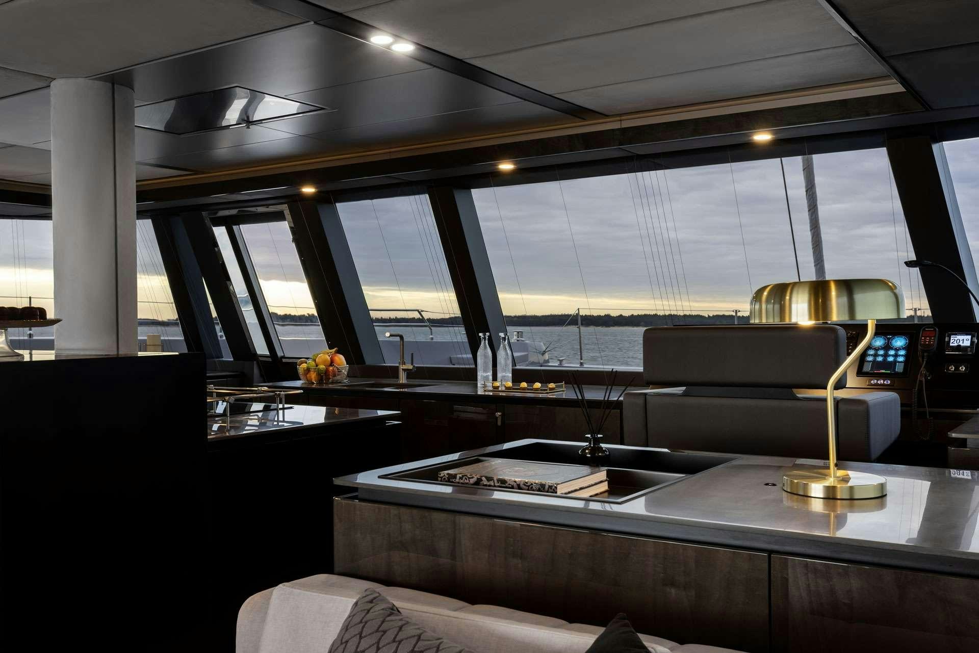 a room with a desk and a lamp aboard XMOTION Yacht for Charter