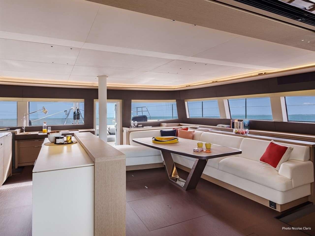 a room with a couch and a table aboard REVE BLEU Yacht for Charter