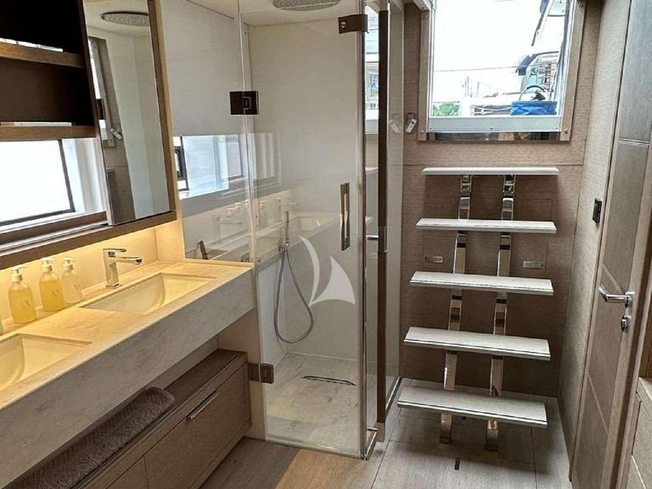 a bathroom with a shower unit and sink aboard REVE BLEU Yacht for Charter