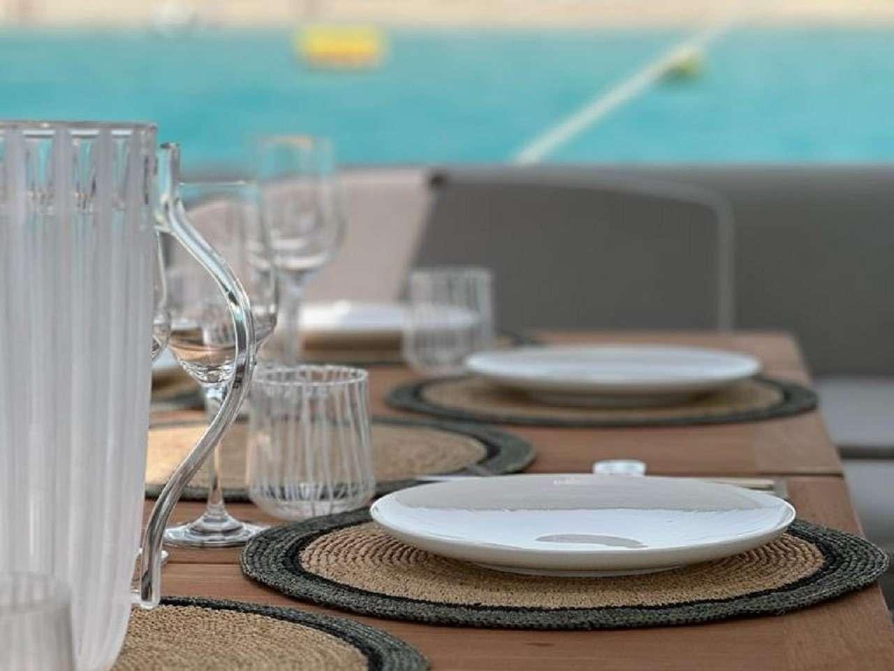 empty plates and glasses on a table aboard REVE BLEU Yacht for Charter