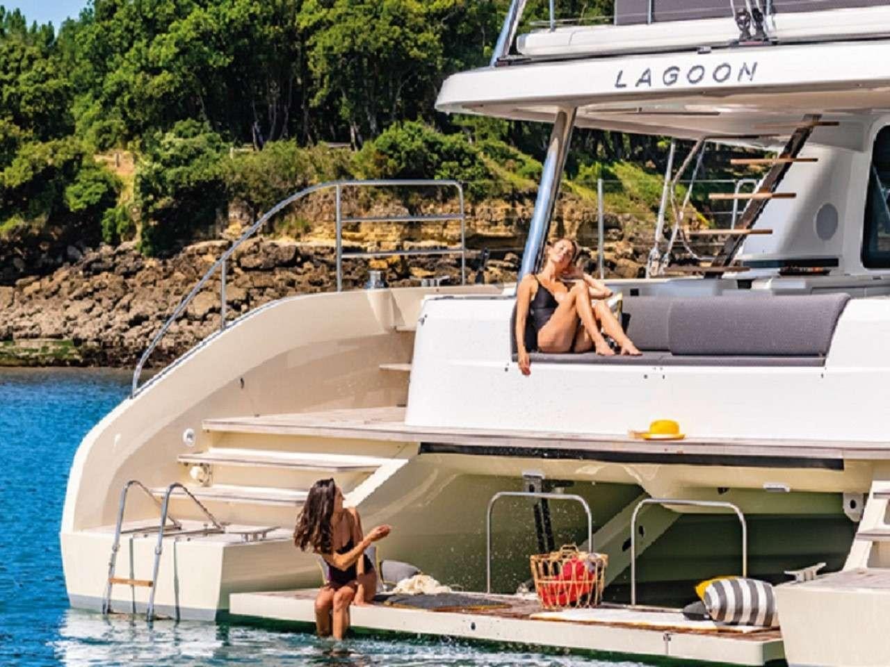 a couple of people sitting on a boat in the water aboard REVE BLEU Yacht for Charter
