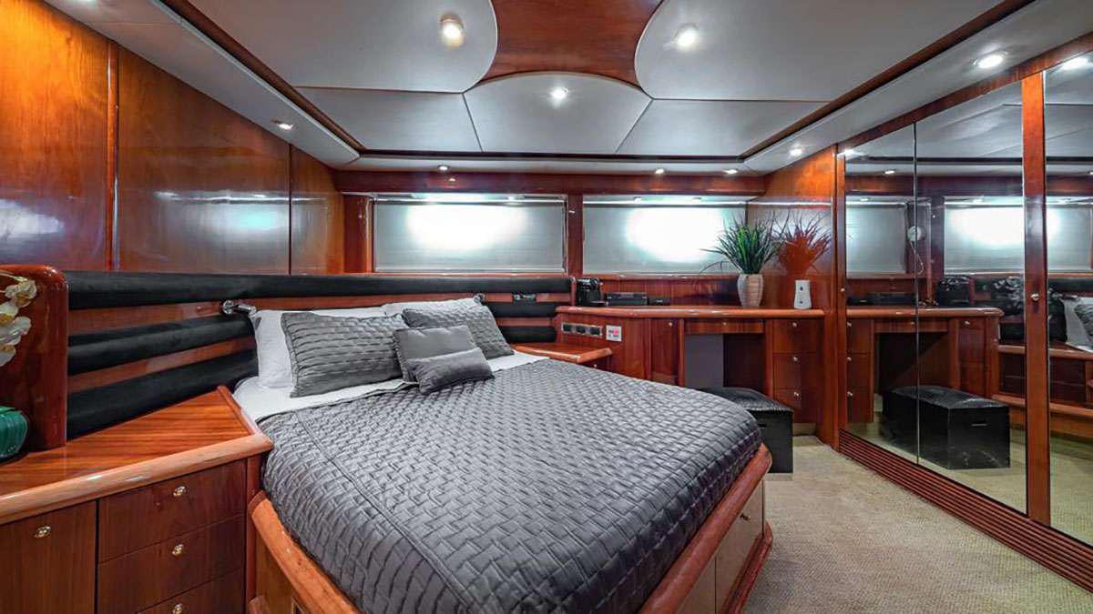 a room with a bed and a desk aboard GIULI Yacht for Charter
