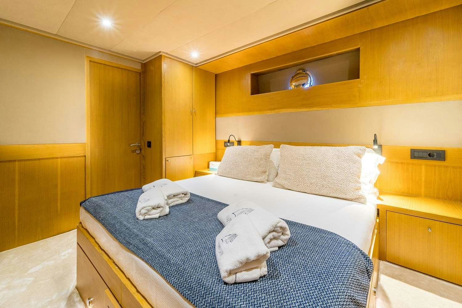 a bed with pillows aboard HAPPY DAYS Yacht for Charter
