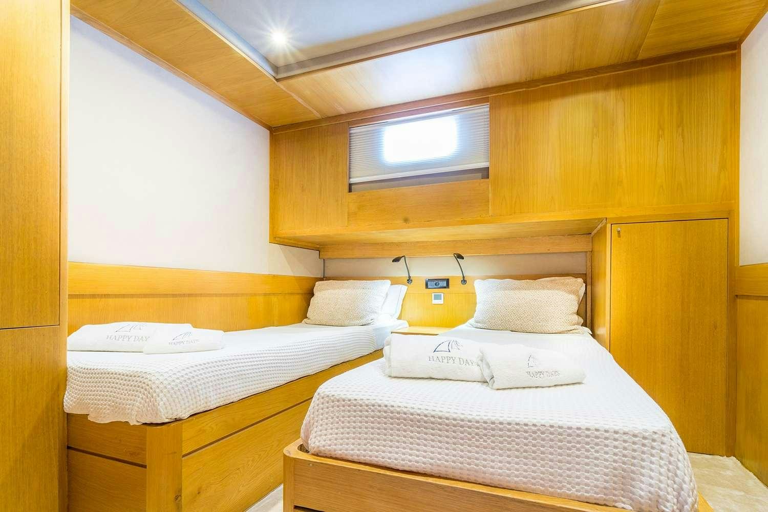 a couple of beds in a room aboard HAPPY DAYS Yacht for Charter