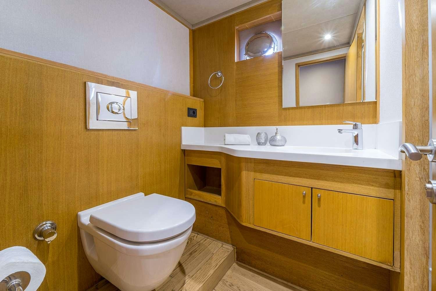 a bathroom with a toilet and a sink aboard HAPPY DAYS Yacht for Charter