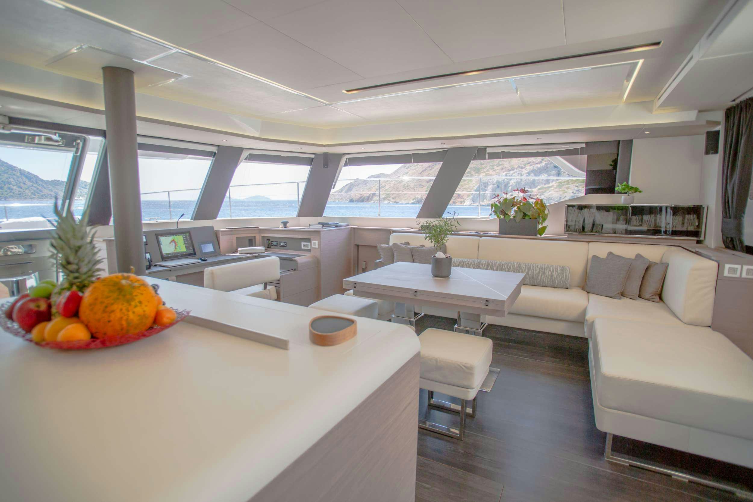 a large kitchen with a table and chairs aboard JEWEL Yacht for Charter