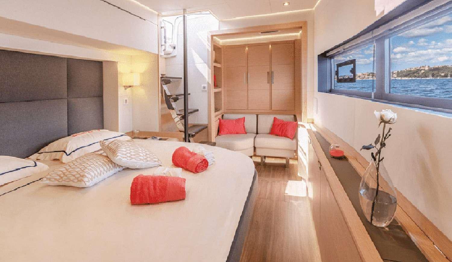 a room with a bed and a table aboard JEWEL Yacht for Charter