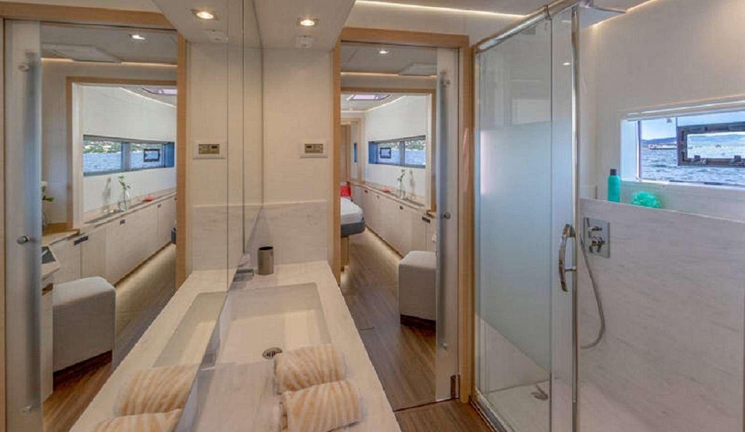 a bathroom with a large glass shower aboard JEWEL Yacht for Charter