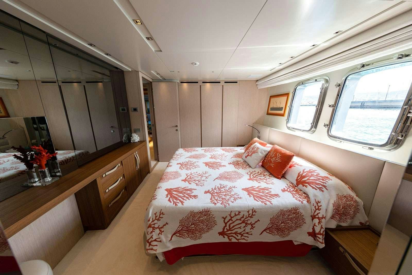 a bedroom with a large bed aboard VITTORIA Yacht for Charter
