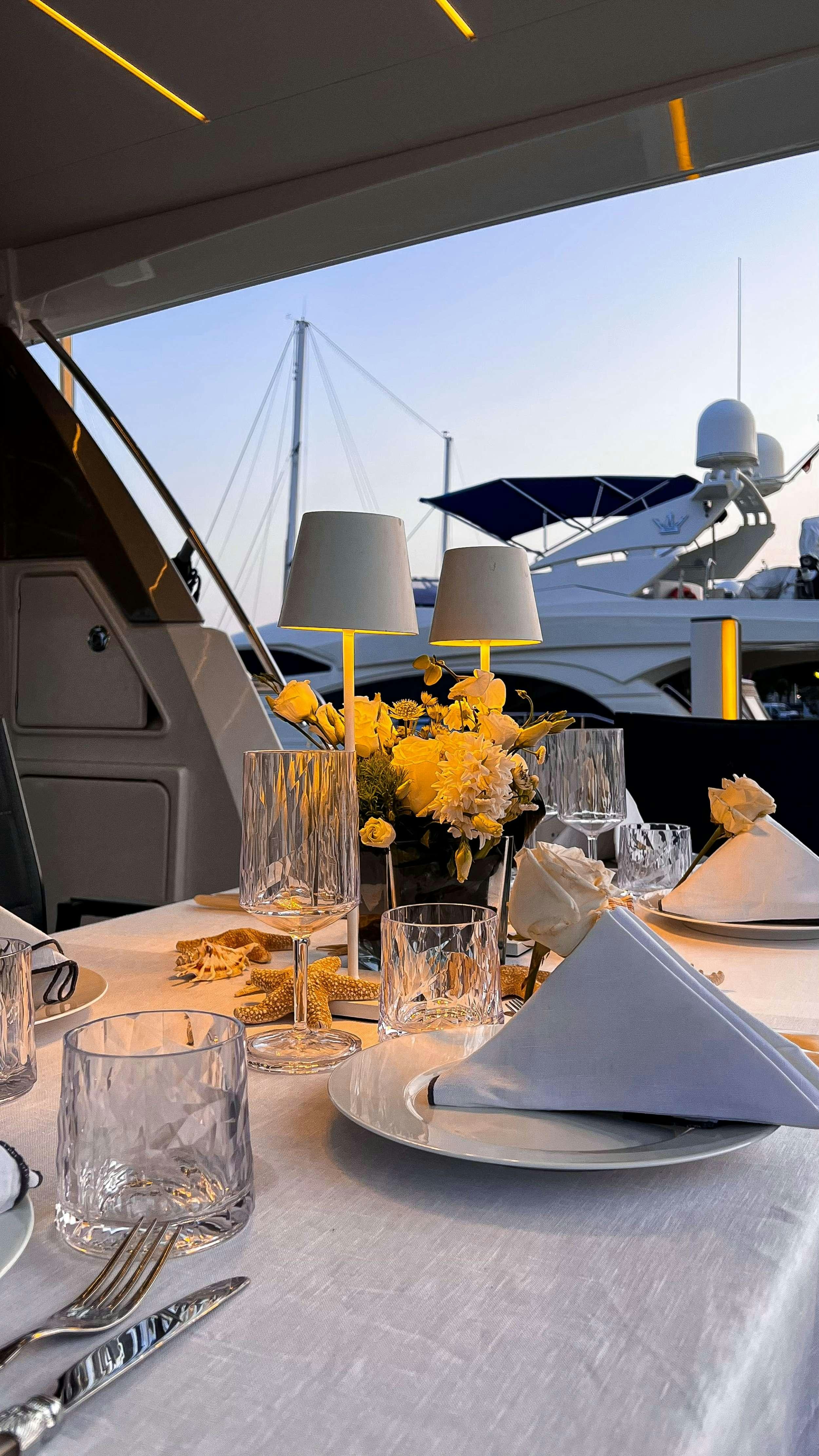 a table with glasses and plates on it aboard ROMY ONE Yacht for Charter