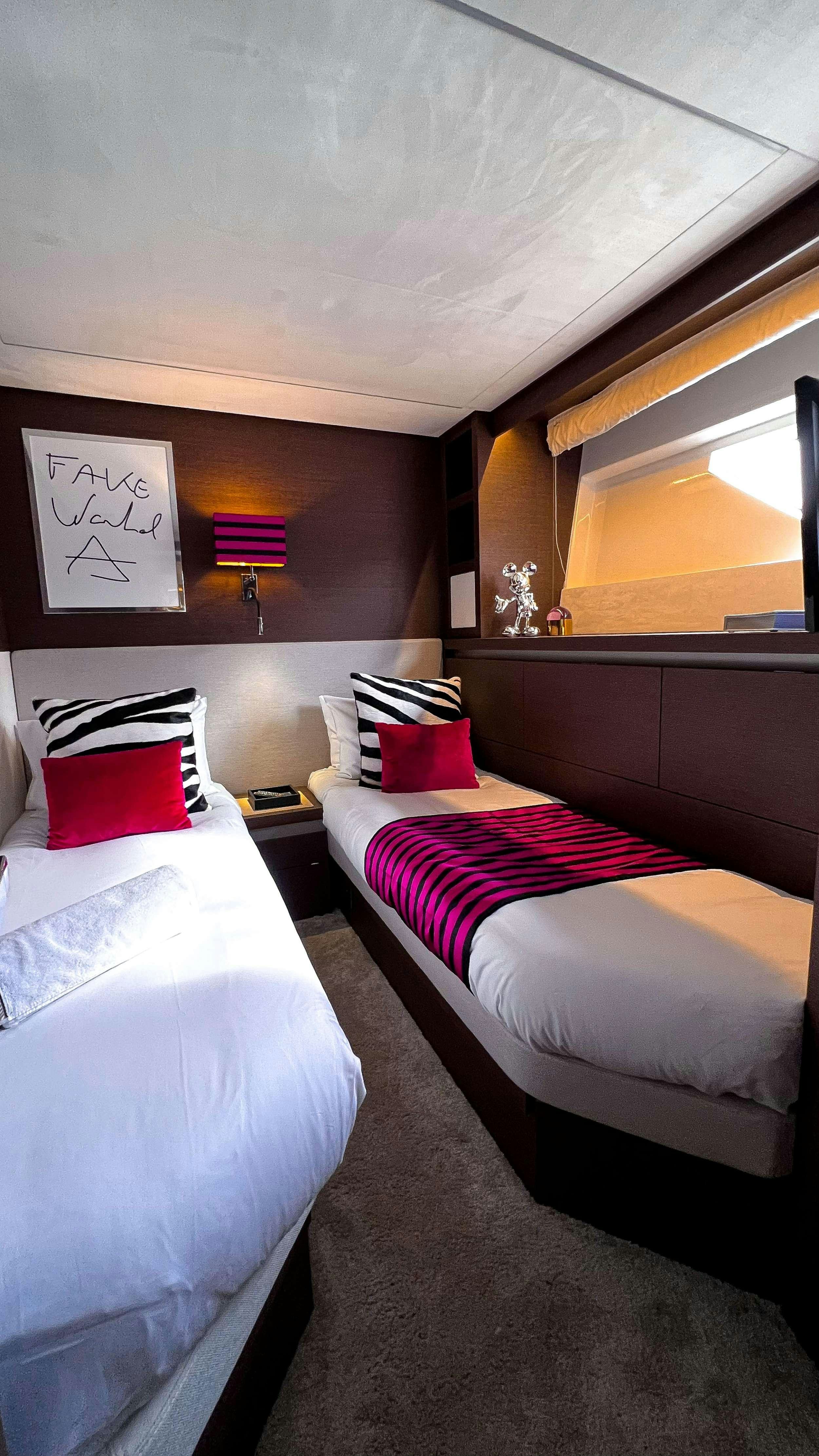 a couple of beds in a room aboard ROMY ONE Yacht for Charter