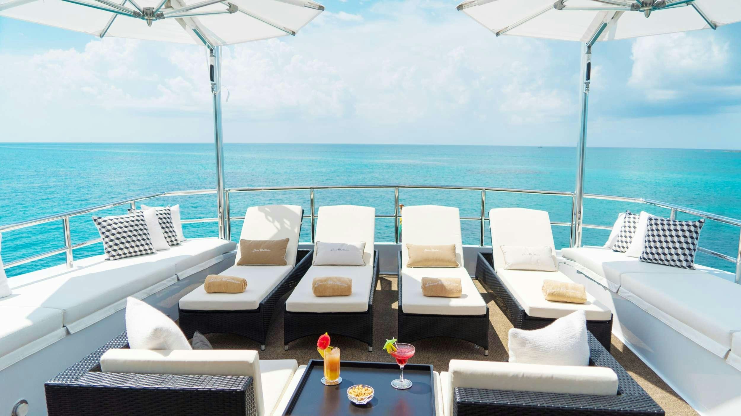 a room with a table chairs and a large body of water aboard GRAND ILLUSION Yacht for Charter