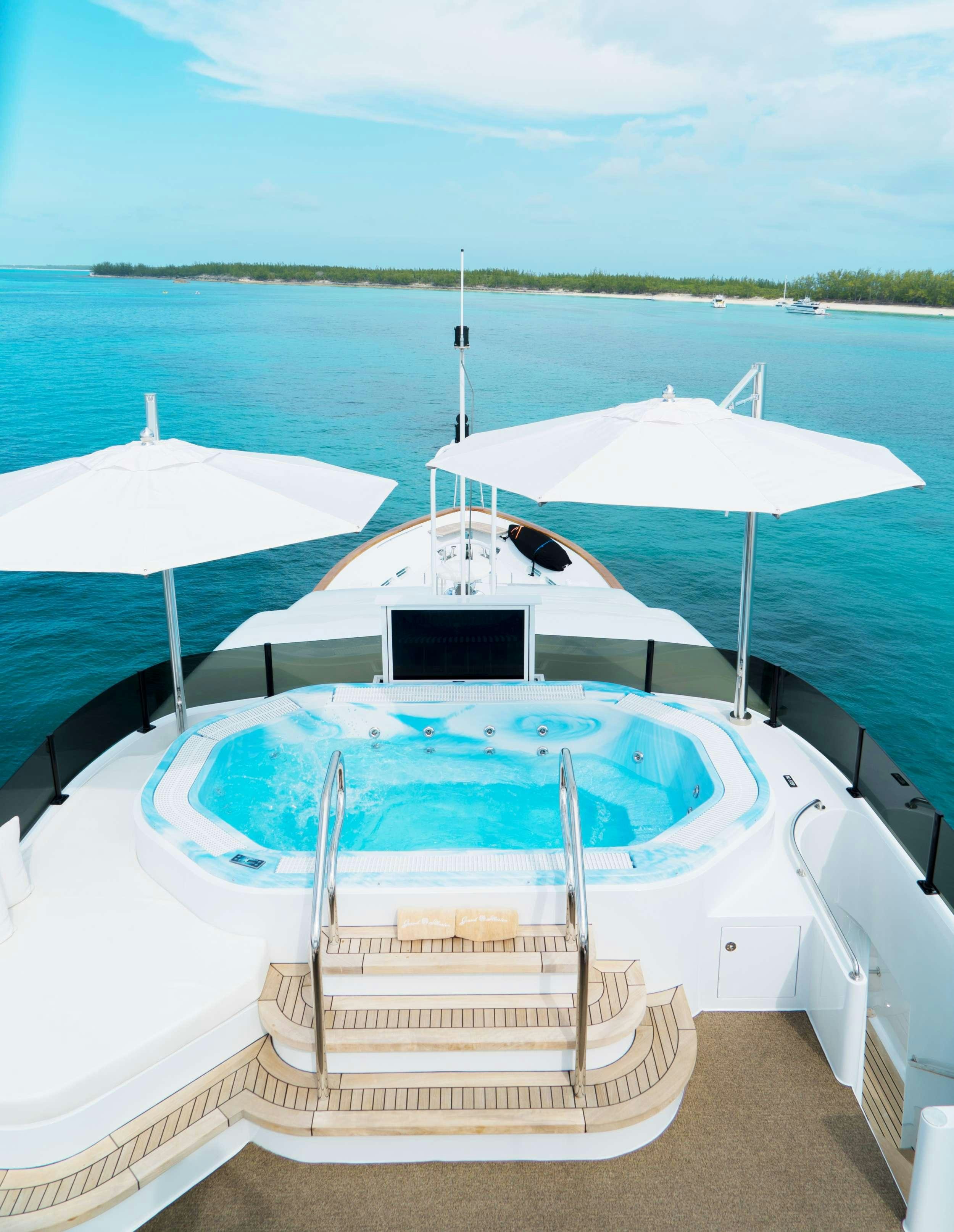 a couple of umbrellas sit on a boat aboard GRAND ILLUSION Yacht for Charter