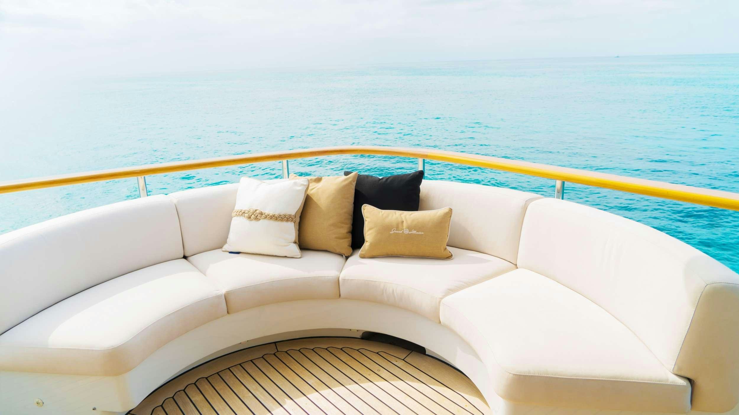 a couch with pillows on it aboard GRAND ILLUSION Yacht for Charter