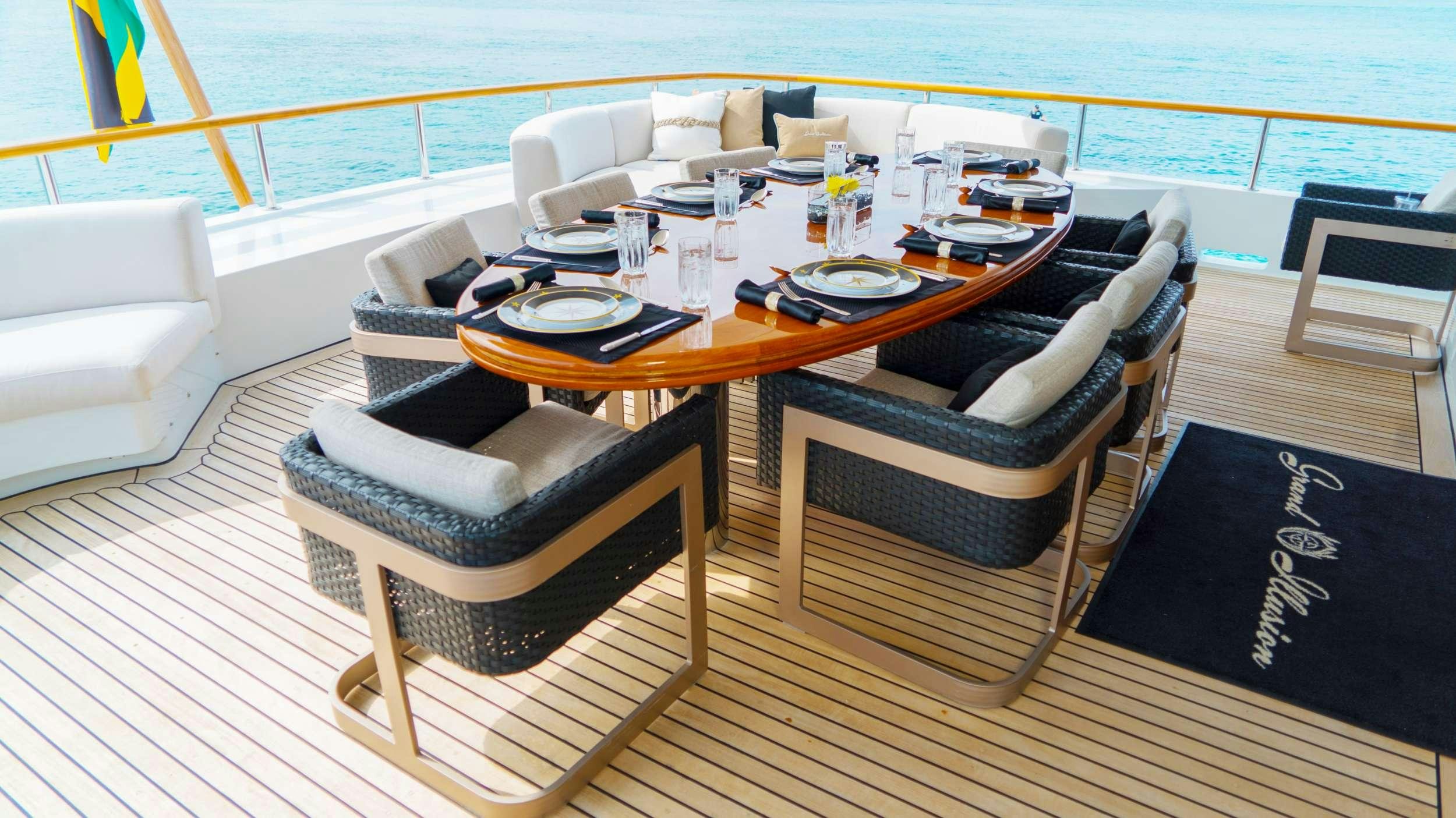 a table with chairs around it aboard GRAND ILLUSION Yacht for Charter