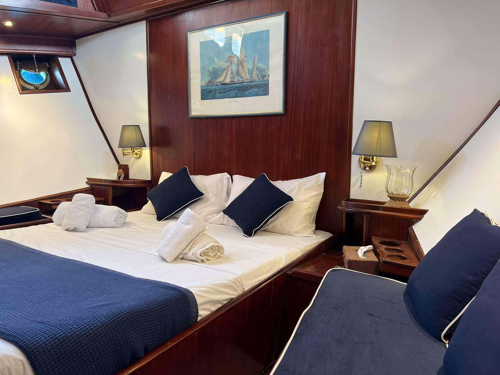 a hotel room with two beds aboard APHRODITE Yacht for Charter