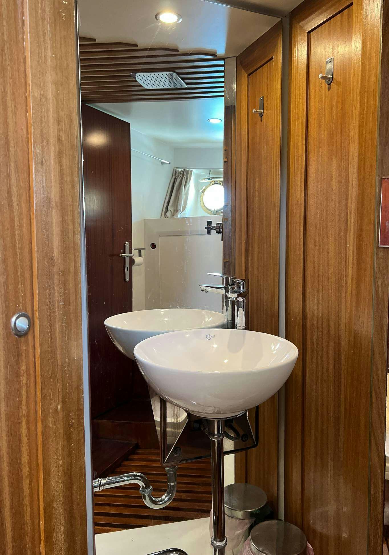 a bathroom with a sink and a mirror aboard APHRODITE Yacht for Charter