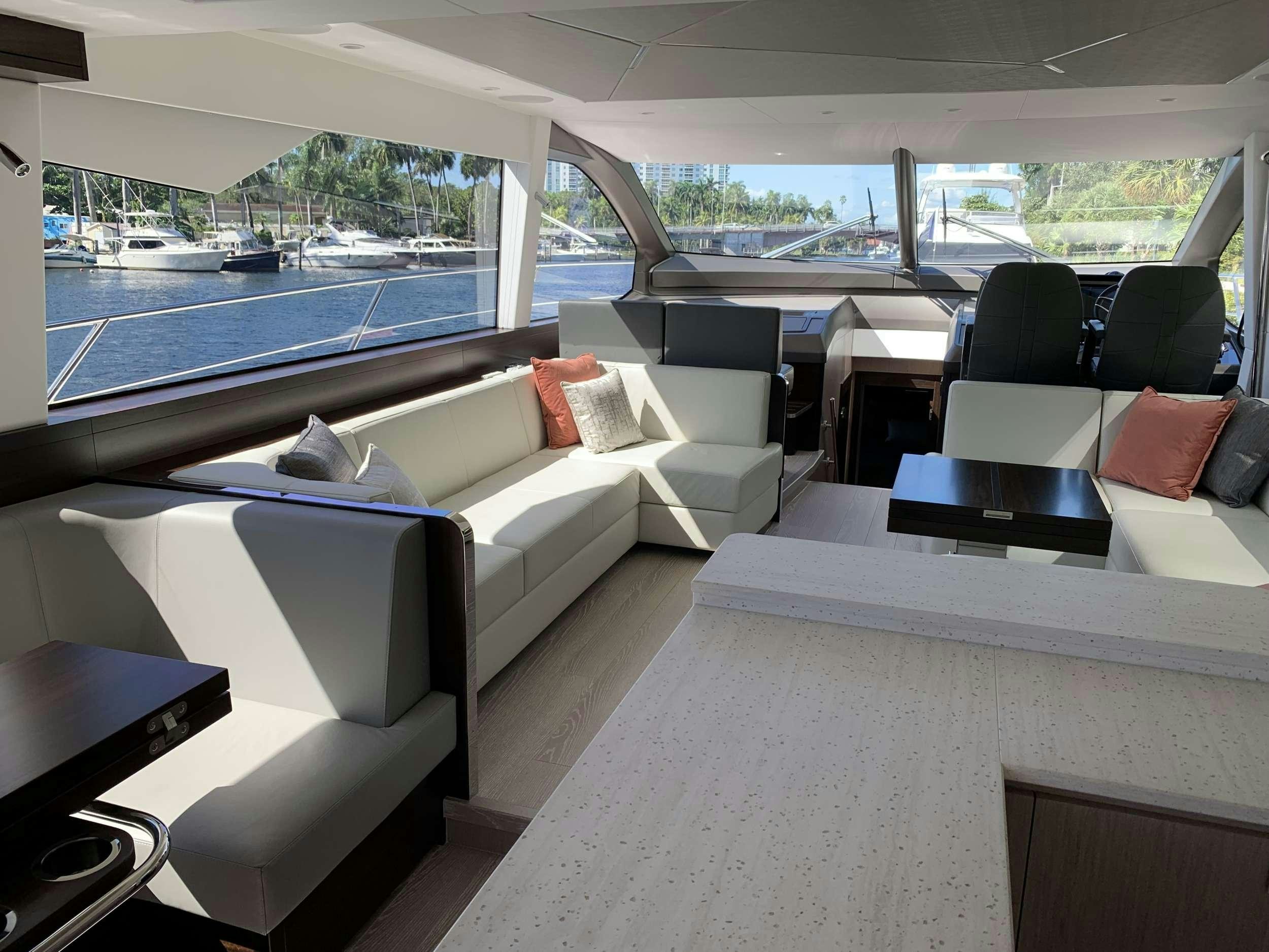 a room with a couch and a table and a pool aboard EARL GREY Yacht for Charter
