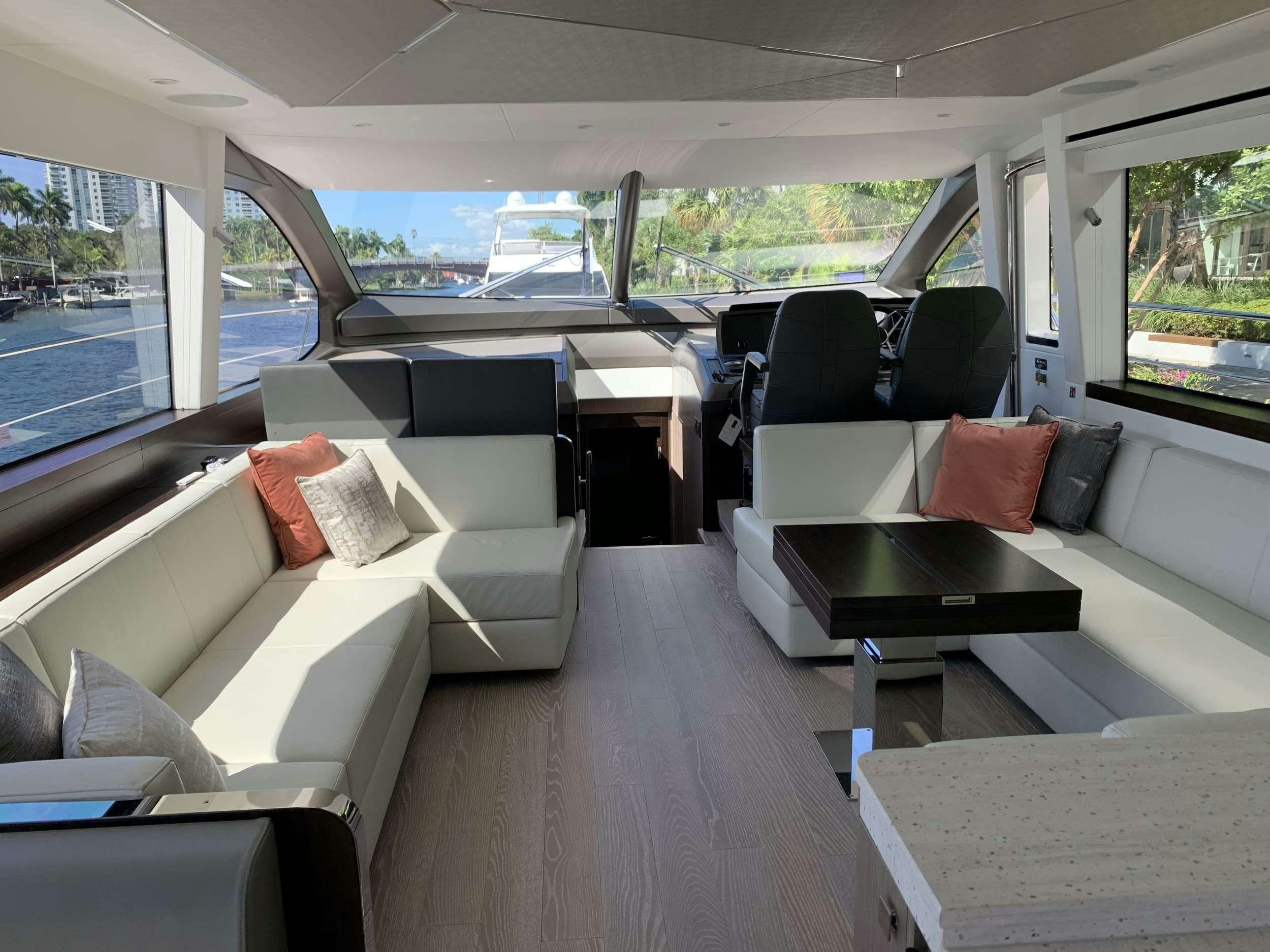 a room with a couch and a table with chairs aboard EARL GREY Yacht for Charter
