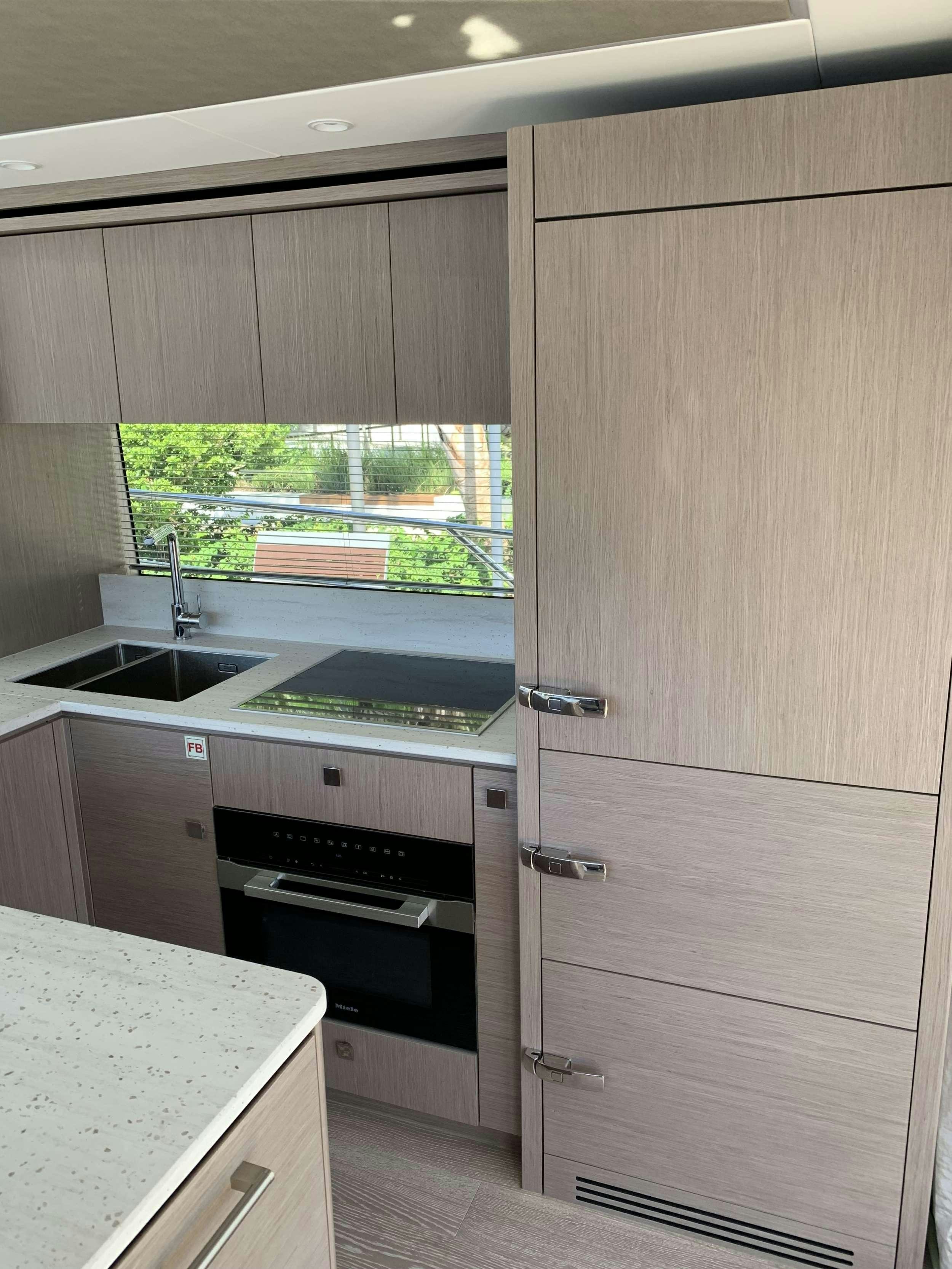 a kitchen with wooden cabinets aboard EARL GREY Yacht for Charter