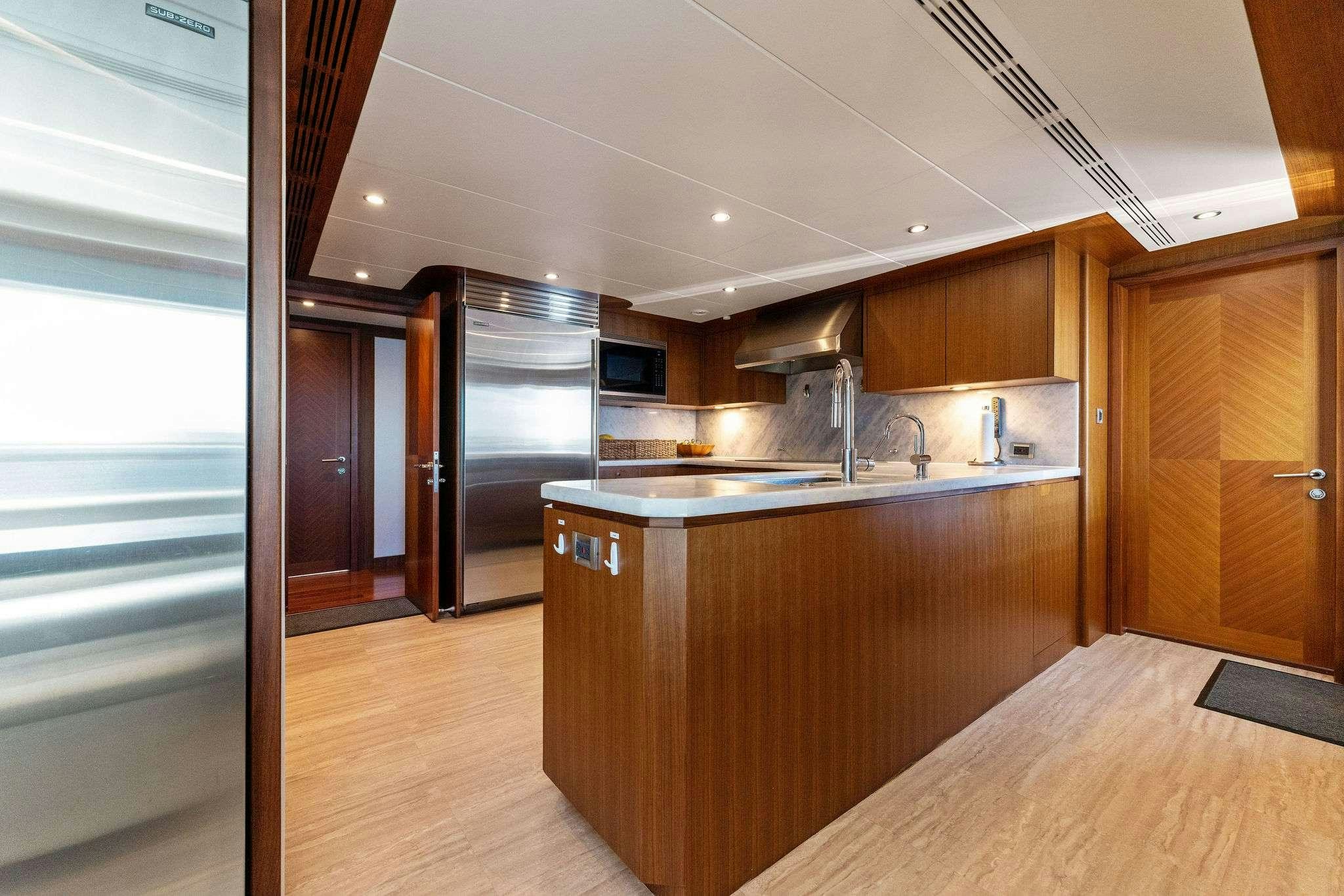 a kitchen with wooden cabinets aboard LONG AWEIGHTED Yacht for Charter