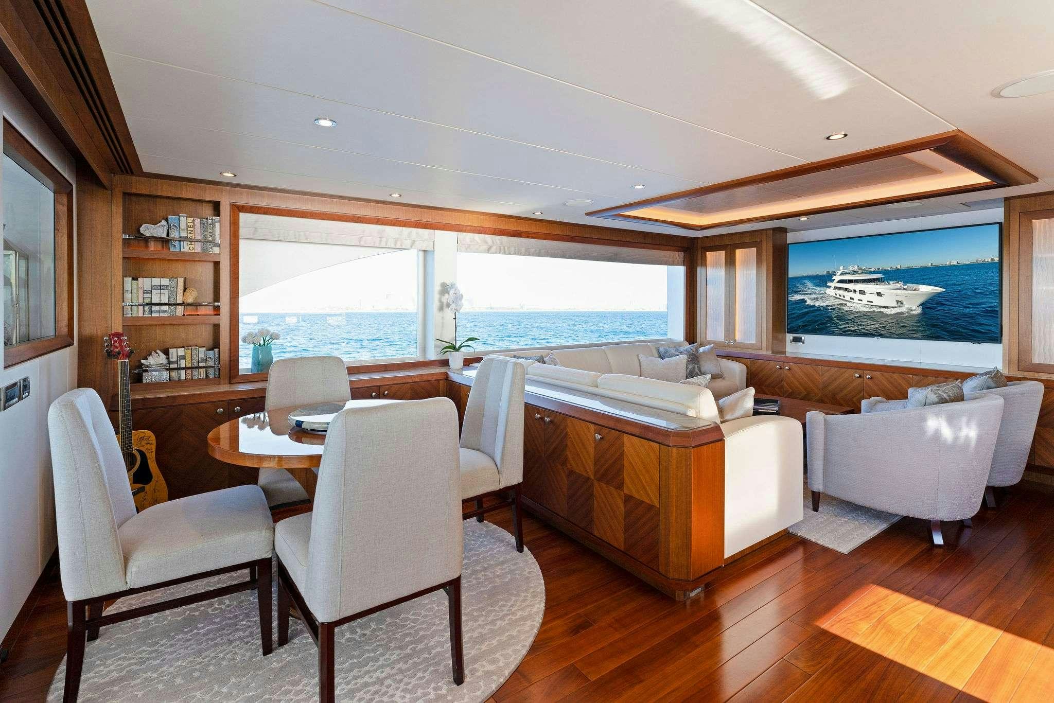 a room with a table chairs and a window aboard LONG AWEIGHTED Yacht for Charter