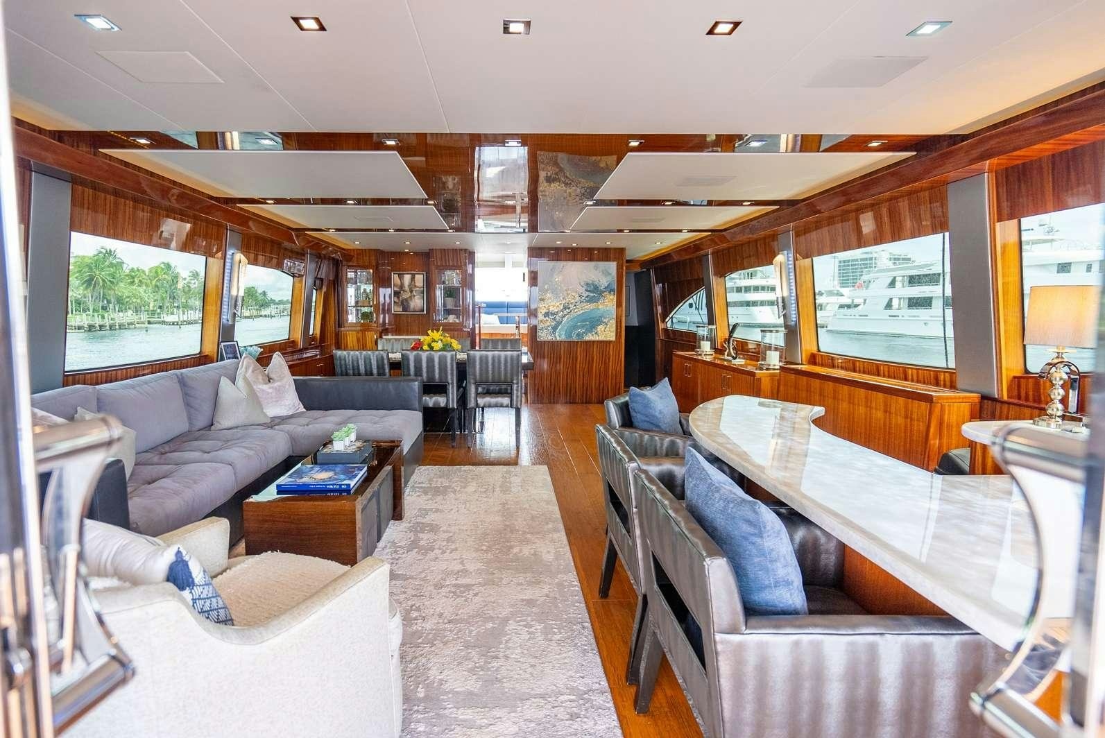 a living room with a couch and a table aboard DONE DEAL Yacht for Charter
